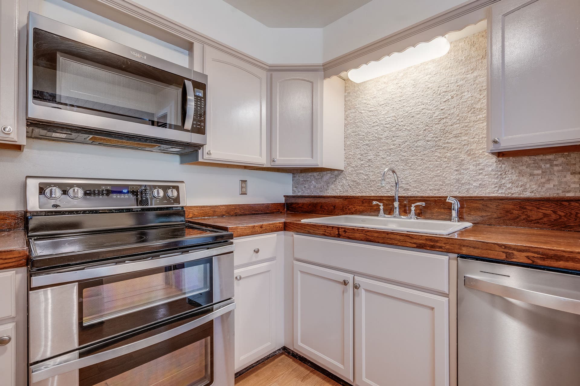 244 Bench Drive, Kalispell, MT 59901 Functional kitchen and dining space featuring solid 1980s build quality and warm wood accents throughout.