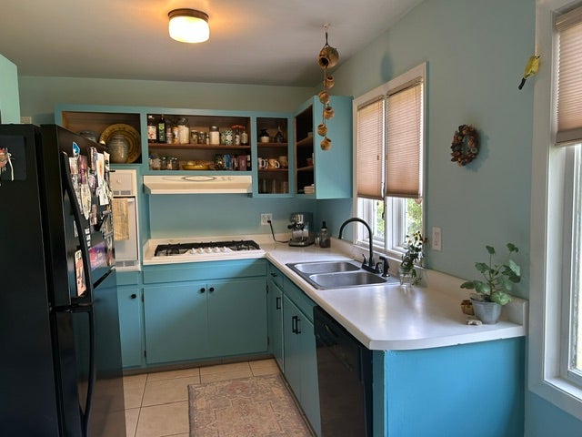 Kitchen featuring a built-in wall oven, gas cooktop, and a double basin stainless steel sink with a gooseneck faucet