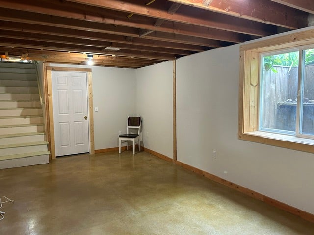 Entry to lower level living space with stained concrete floors
