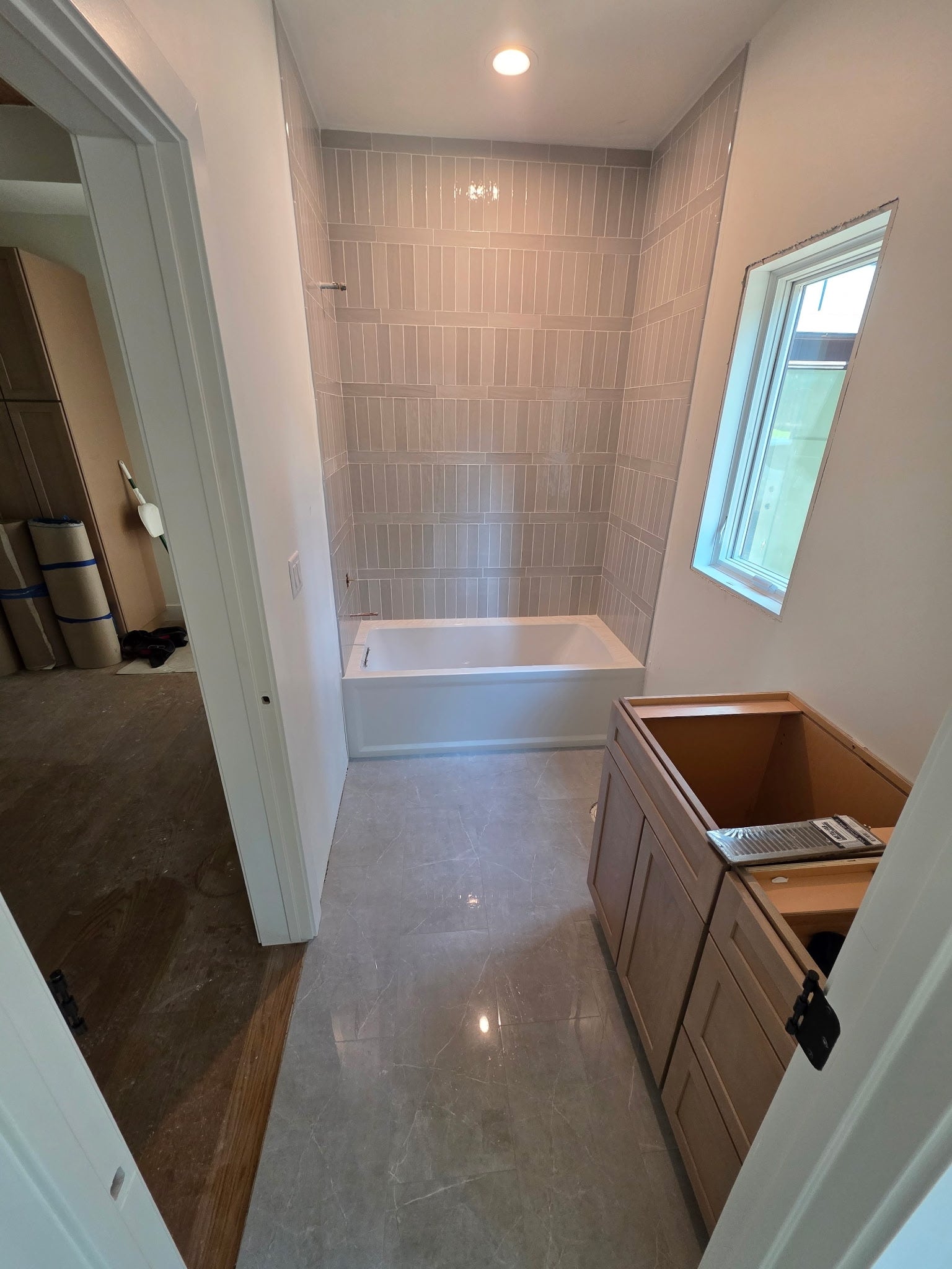 33542 Westview Drive, Bigfork, MT 59911 Main-level full bathroom in progress with completed of shower tile and flooring