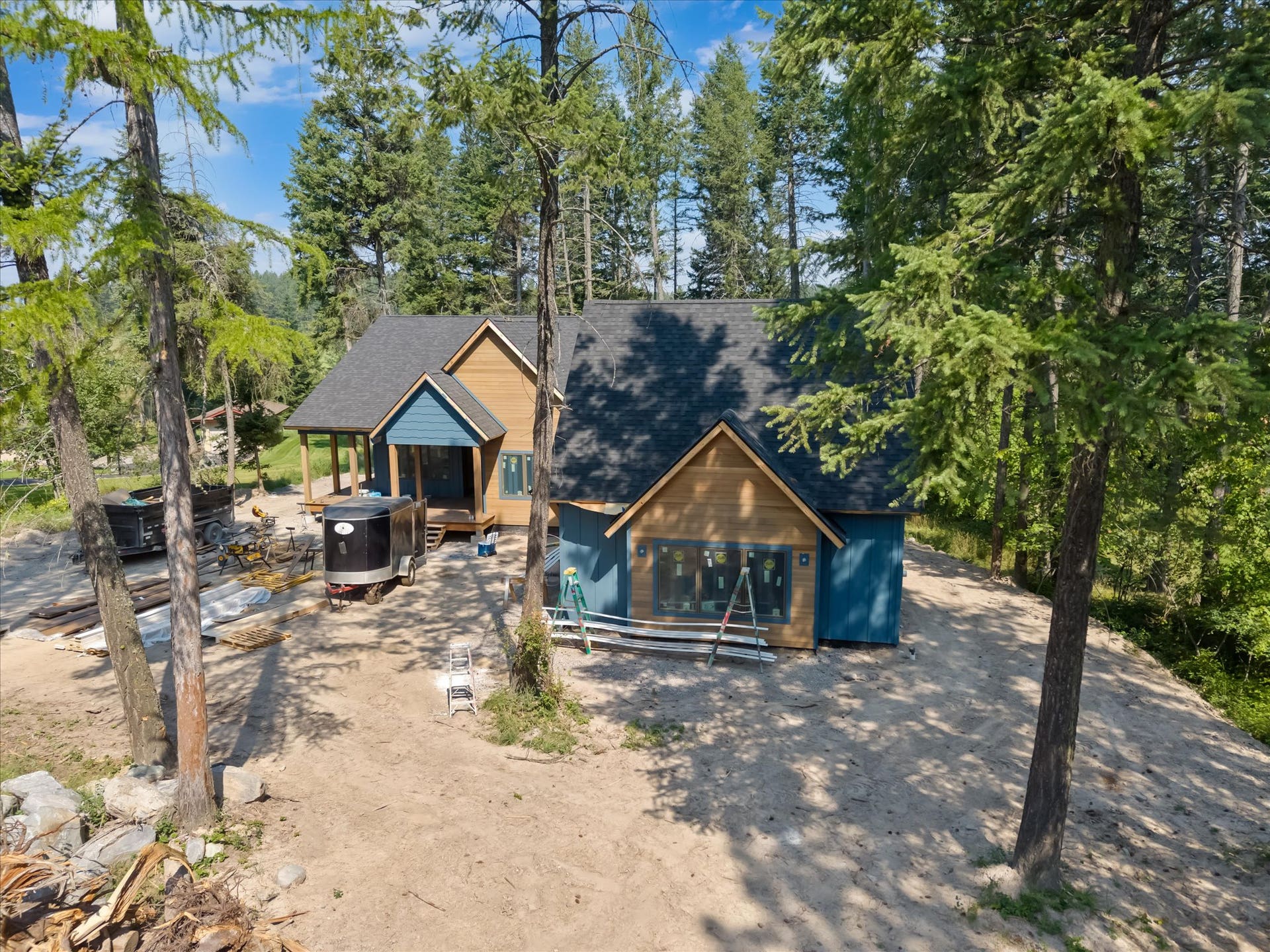 33542 Westview Drive, Bigfork, MT 59911 Elevated front exterior view highlighting the architectural rooflines and timber accents