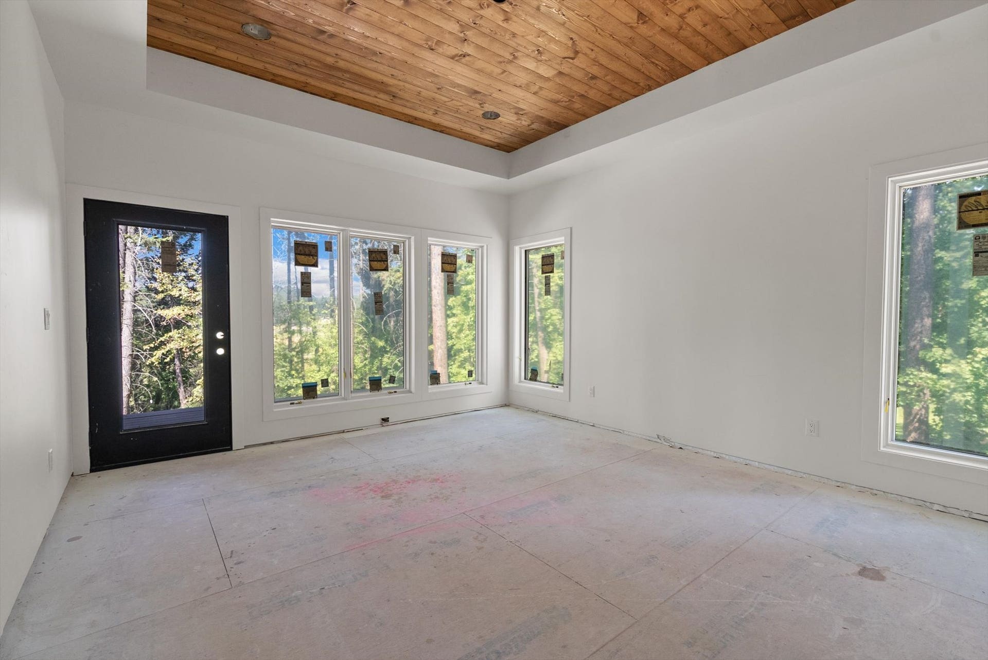 33542 Westview Drive, Bigfork, MT 59911 Primary bedroom suite featuring wall-to-wall windows and direct access to the covered deck