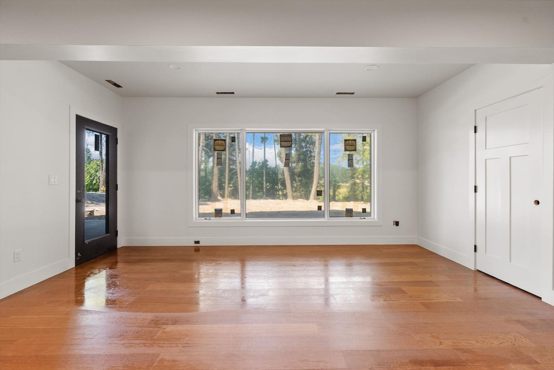 33542 Westview Drive, Bigfork, MT 59911 Walkout lower-level living area with scenic backyard views through large Pella windows