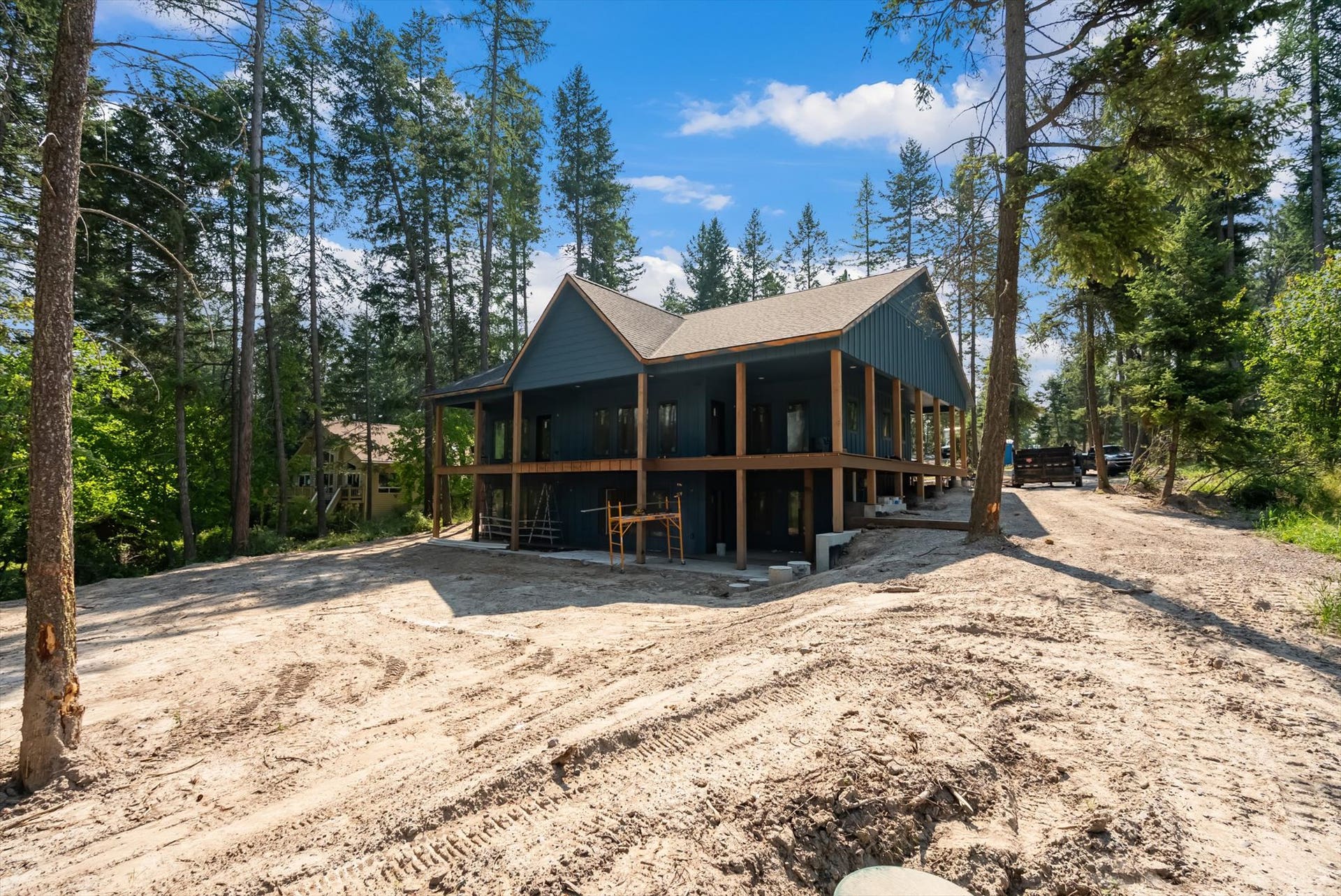 33542 Westview Drive, Bigfork, MT 59911 Rear side elevation detailing the two-story structural layout and surrounding pine forest