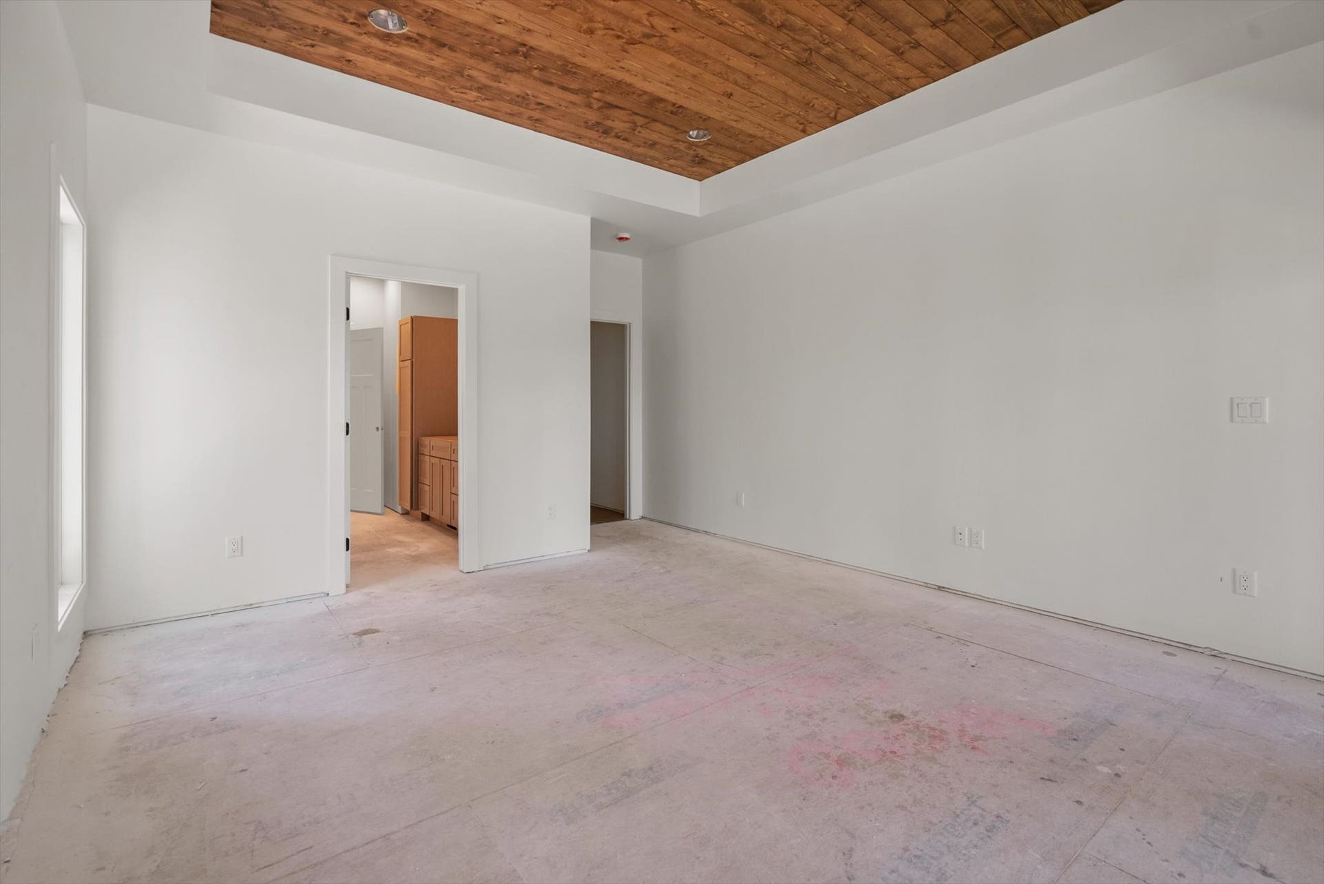 33542 Westview Drive, Bigfork, MT 59911 Main-level primary bedroom suite with tray ceiling and pine wood accents