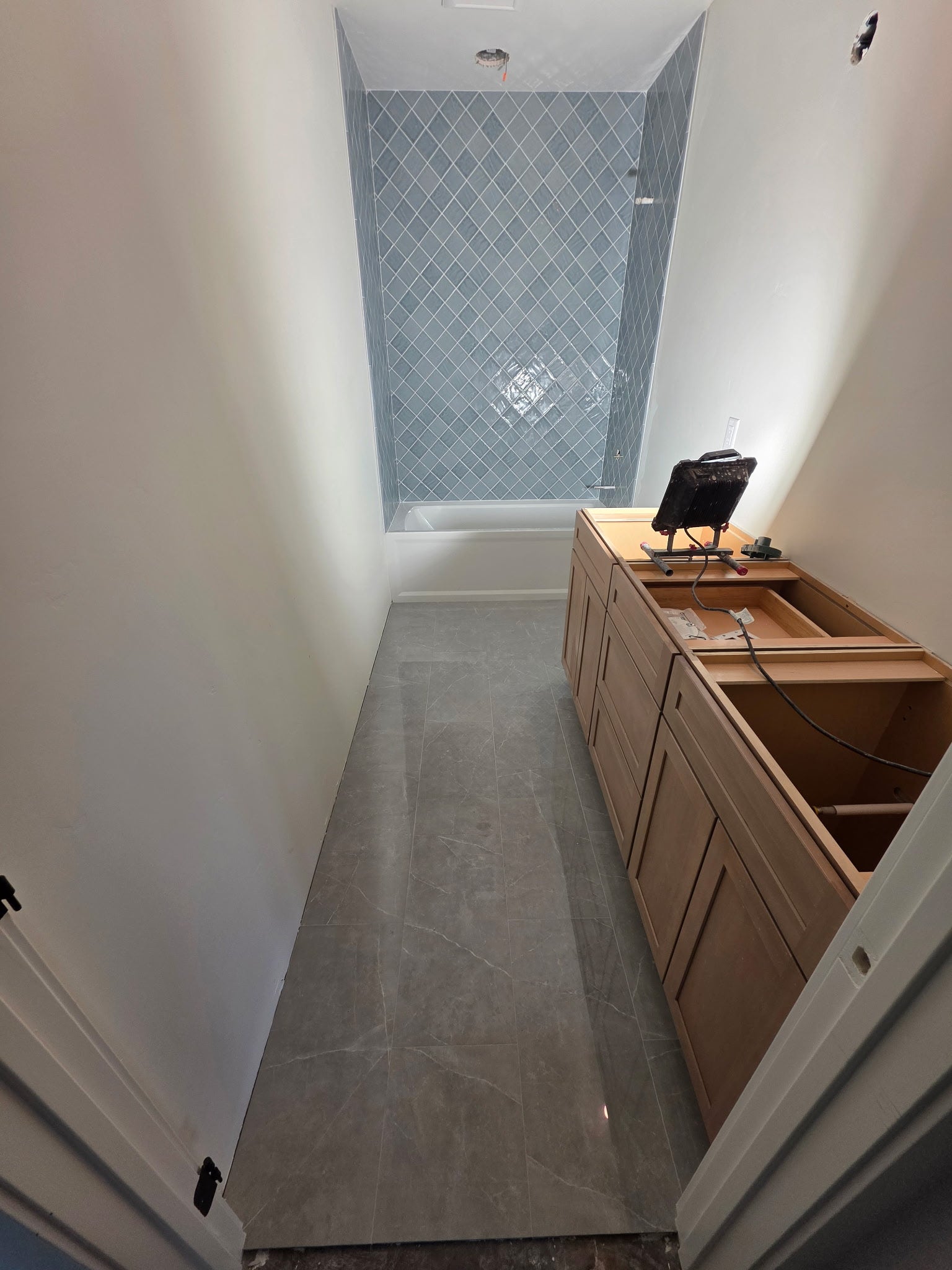 33542 Westview Drive, Bigfork, MT 59911 Lower-level bathroom suite with custom tile shower and flooring completed