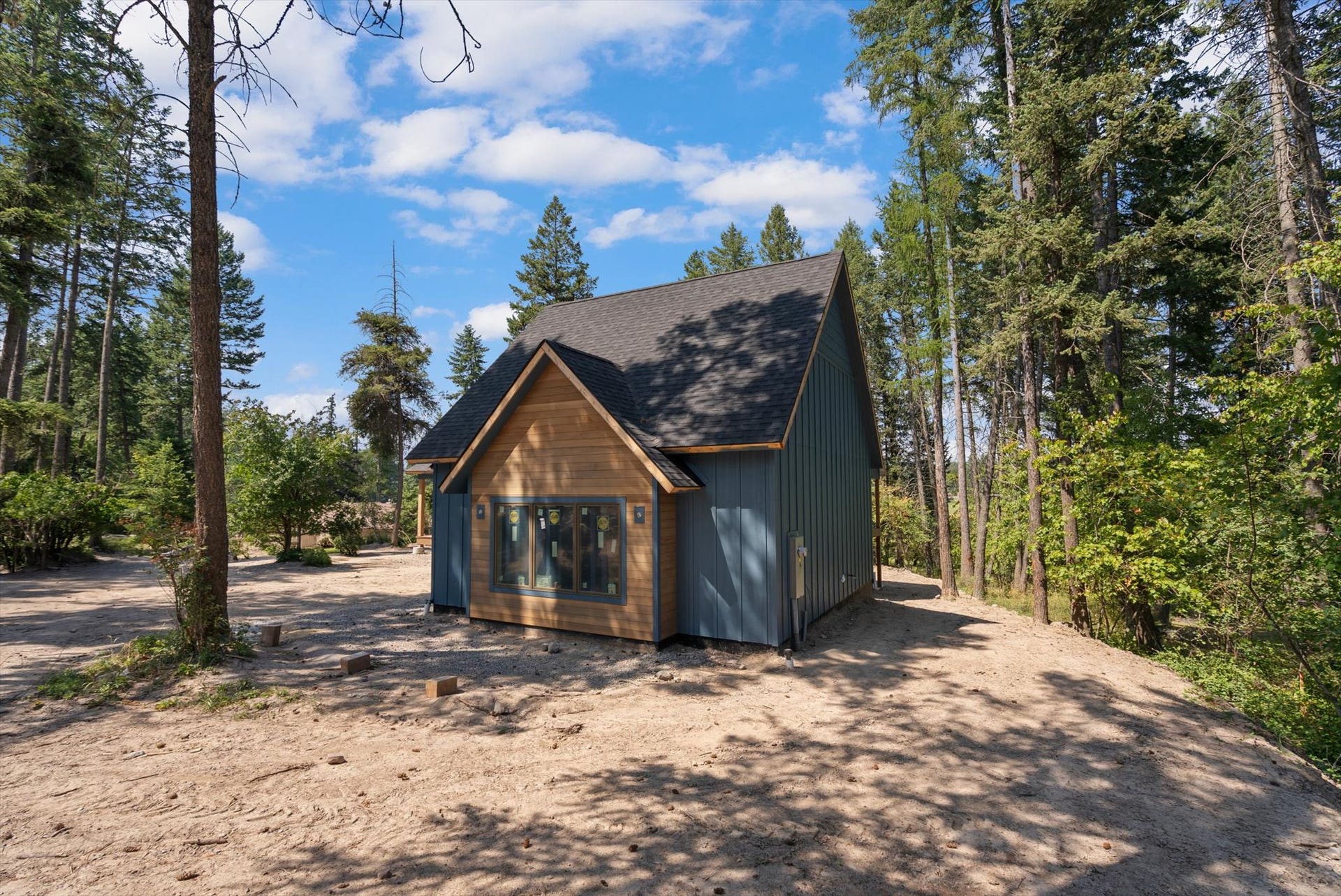 33542 Westview Drive, Bigfork, MT 59911 Side exterior elevation displaying wood siding details and surrounding forest setting
