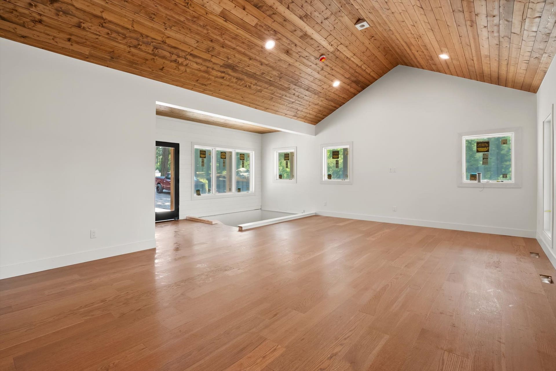33542 Westview Drive, Bigfork, MT 59911 Light-filled main living area featuring vaulted wood ceilings