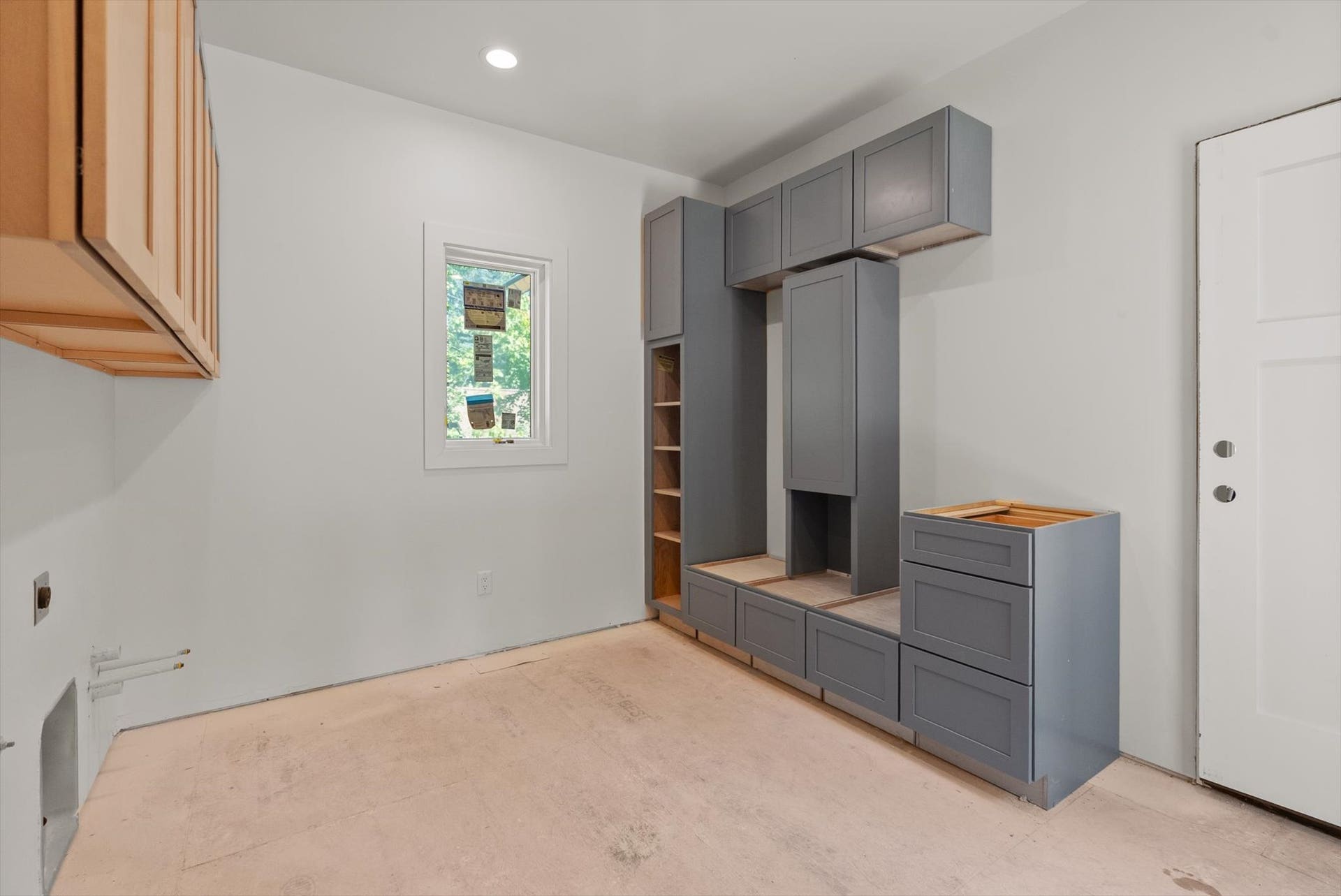 33542 Westview Drive, Bigfork, MT 59911 Mudroom entry and laundry room with built-in bench seating and storage cabinetry