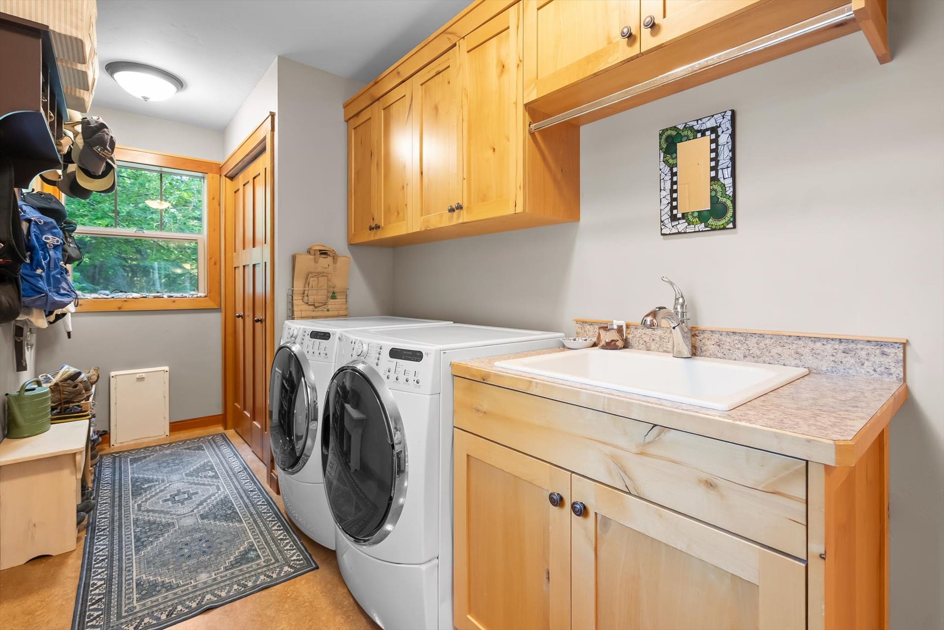 13786 Ridge Loop Road, Bigfork, MT 59911 Laundry room w/ utility sink and alder cabinetry