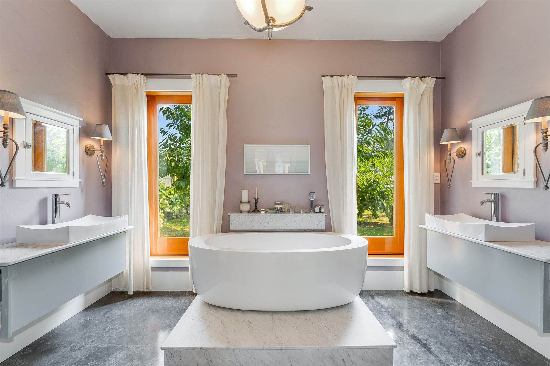 21848 Mt Highway 35, Bigfork, MT 59911 Soaking tub on a raised platform, flanked by two full-length windows