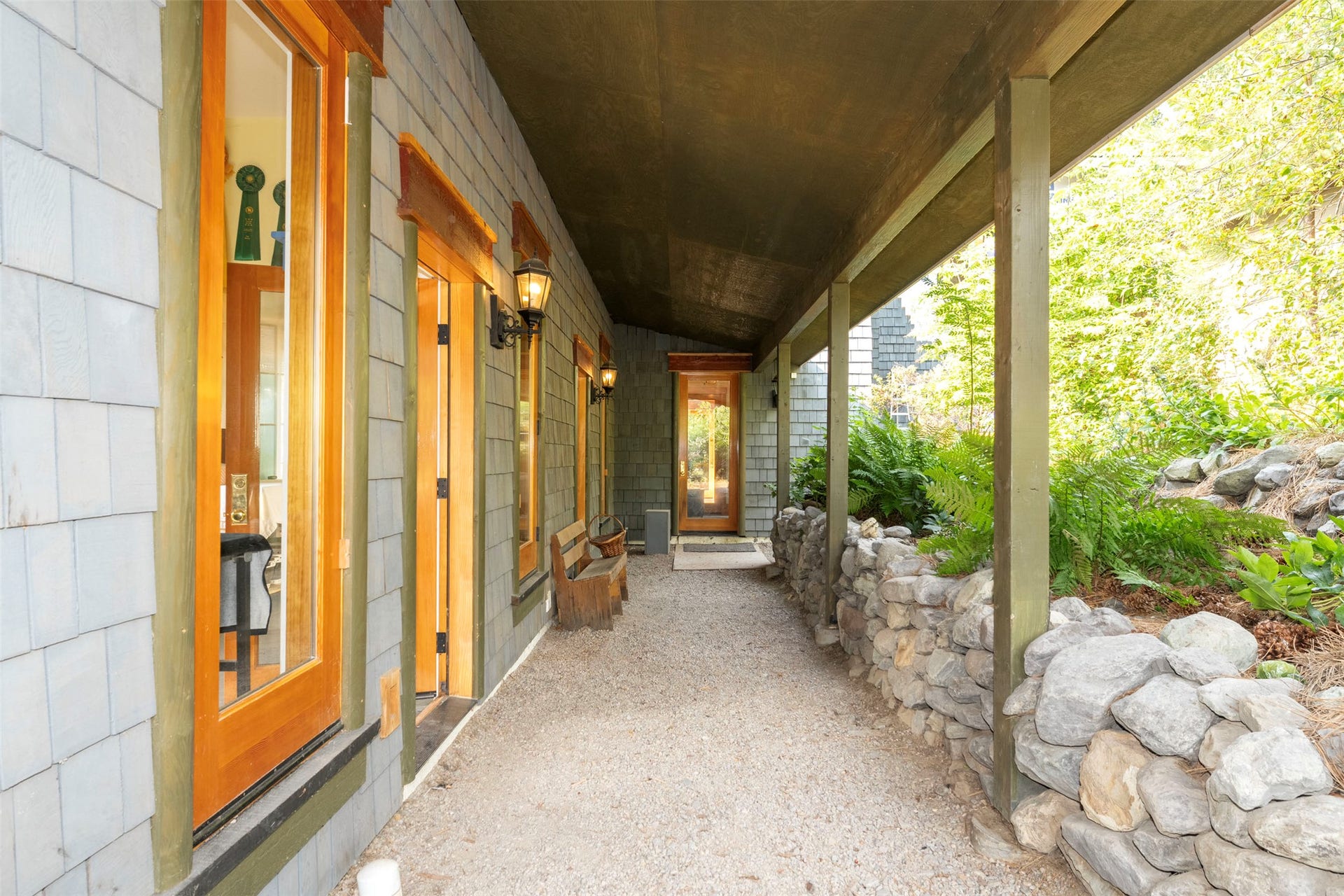 21848 Mt Highway 35, Bigfork, MT 59911 A covered rear patio offers cool shade on sunny days. Access to the work area, office, studio and orchard.