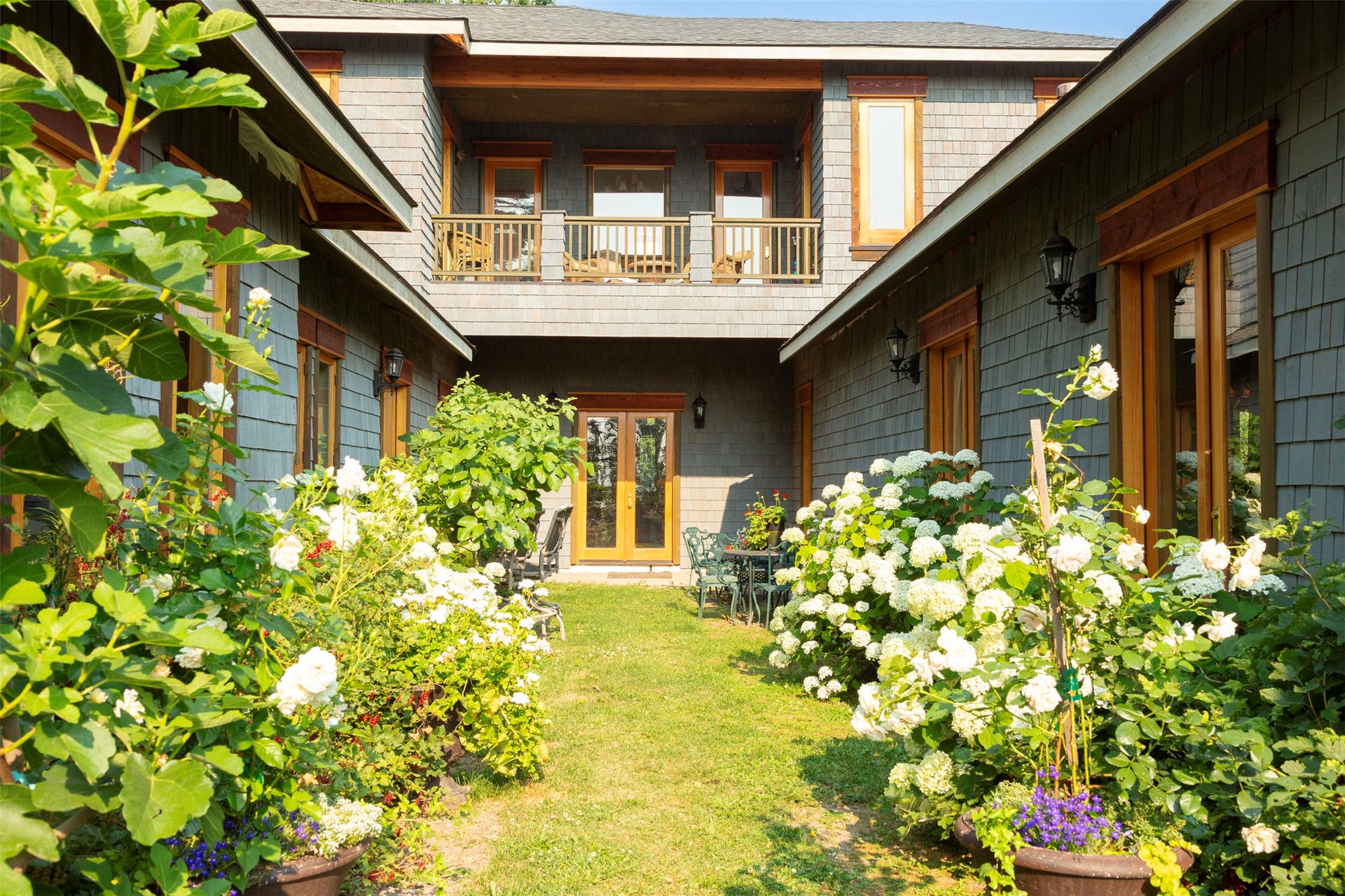 21848 Mt Highway 35, Bigfork, MT 59911 Main front entry through the Courtyard. Front door at center, balcony above.