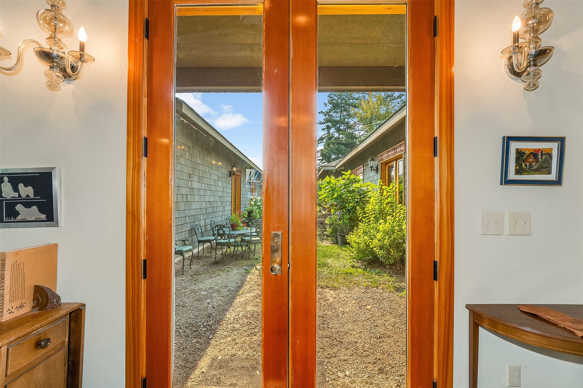 21848 Mt Highway 35, Bigfork, MT 59911 Wood-finish French doors in the living room open to a central landscaped courtyard.