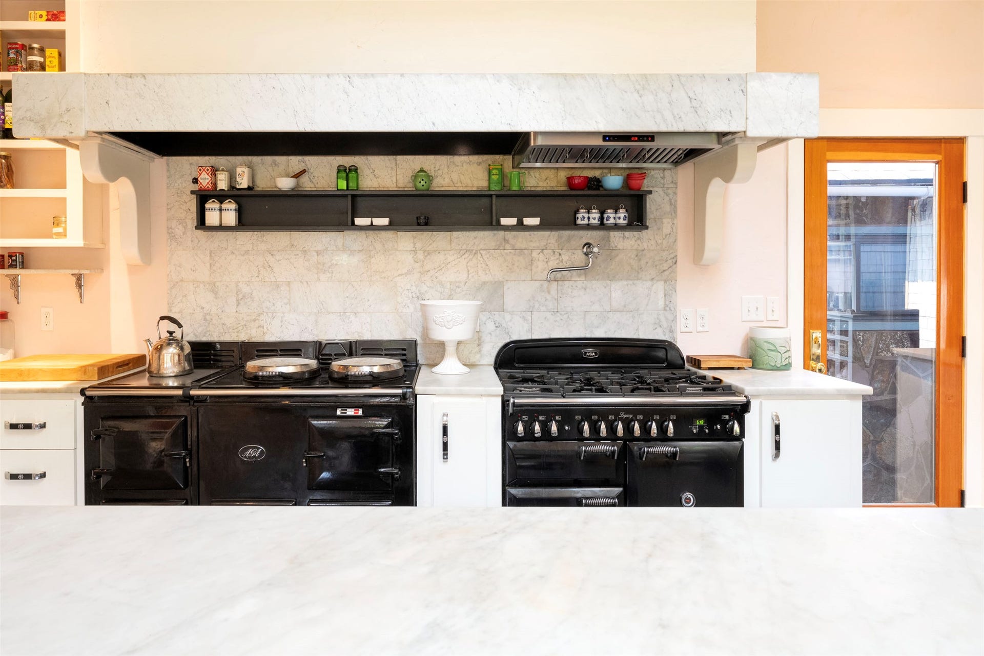 21848 Mt Highway 35, Bigfork, MT 59911 Kitchen workspace featuring a white marble countertop, Aga professional appliances and a white tile backsplash