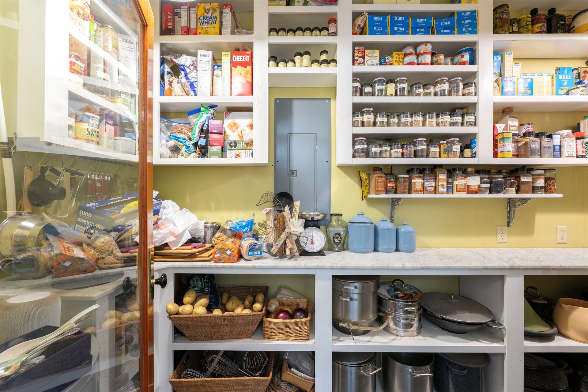 21848 Mt Highway 35, Bigfork, MT 59911 Custom pantry featuring extensive built-in shelving, a spacious countertop, and ample storage for kitchen ingredients