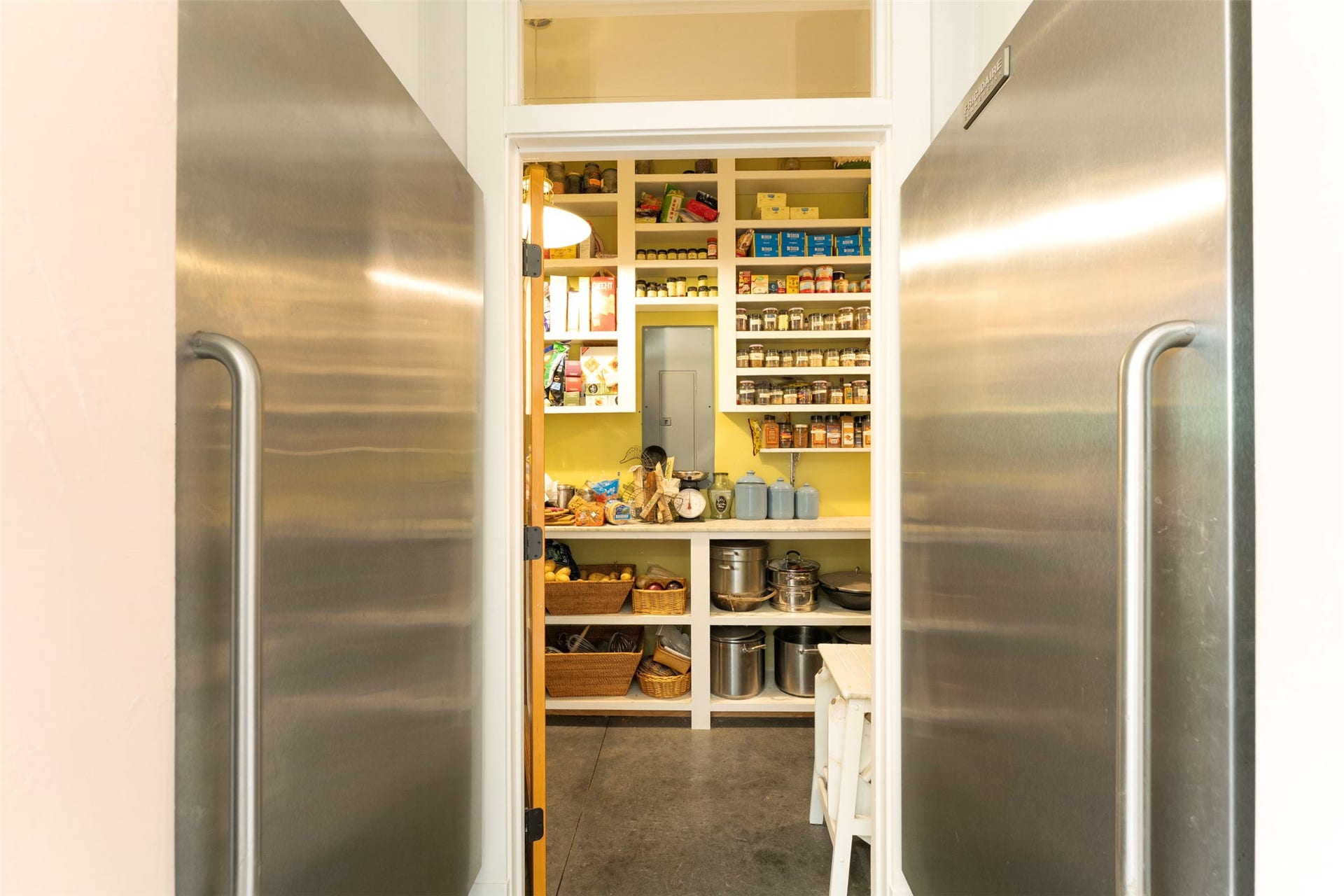 21848 Mt Highway 35, Bigfork, MT 59911 Walk-in pantry featuring open shelving, a built-in countertop, and a pair of large coolers.