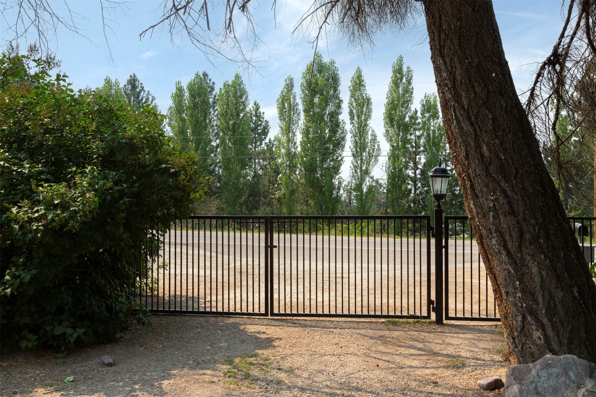 21848 Mt Highway 35, Bigfork, MT 59911 The front gate is among many gates in a property that is entirely fenced and cross fenced to keep deer out and pets and young children in.