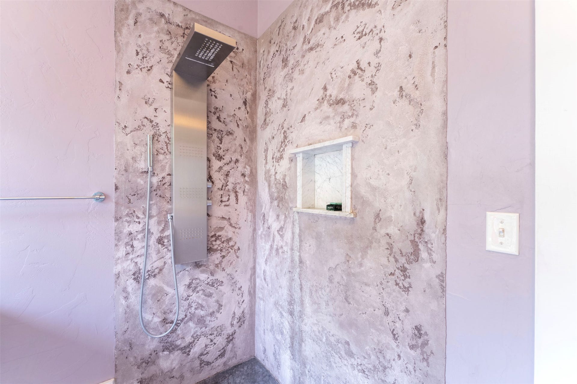 21848 Mt Highway 35, Bigfork, MT 59911 Shower featuring a multi-function stainless steel shower panel, recessed wall niche, and textured wall finish