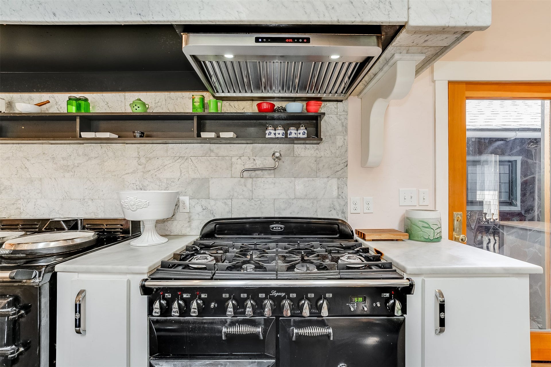 21848 Mt Highway 35, Bigfork, MT 59911 Six burner English Aga pro gas range with marble work surfaces.