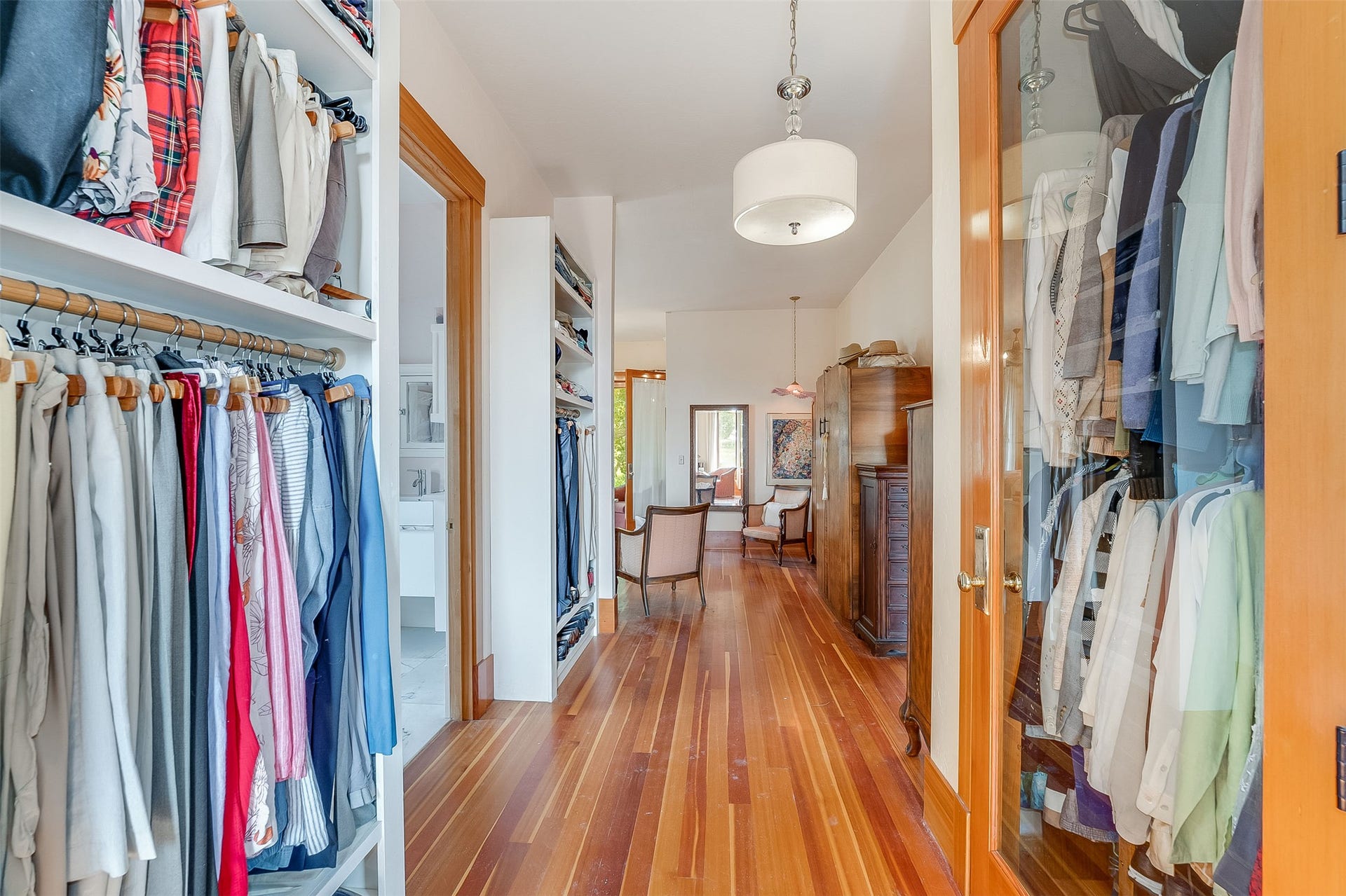 21848 Mt Highway 35, Bigfork, MT 59911 Hallway featuring hardwood flooring, recessed shelving, built-in closet storage, and a drum pendant light fixture