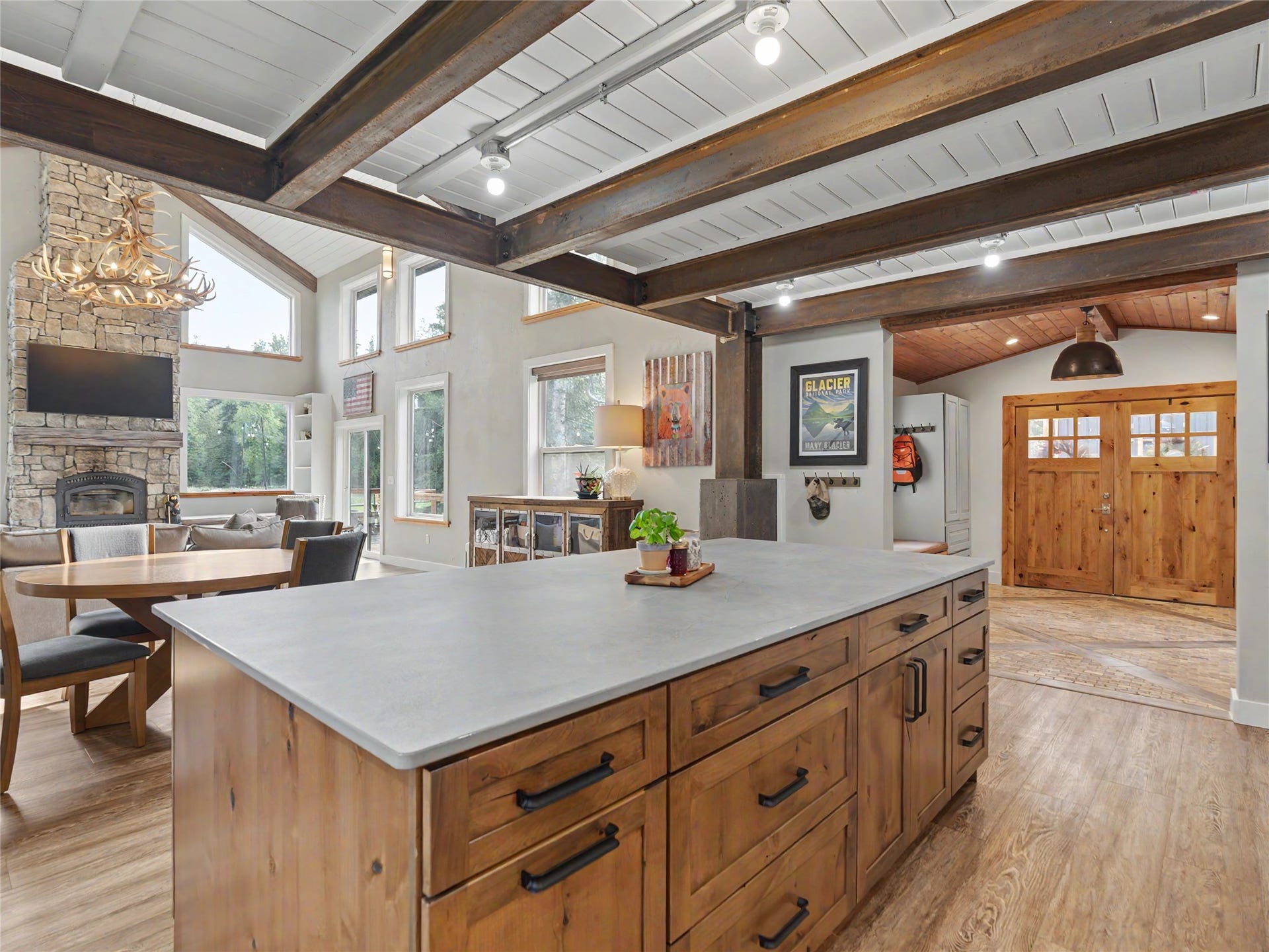 28012 Meadow Creek Road, Bigfork, MT 59911 Open-concept living space featuring a substantial kitchen island with a light-toned countertop and wood-finish cabinetry
