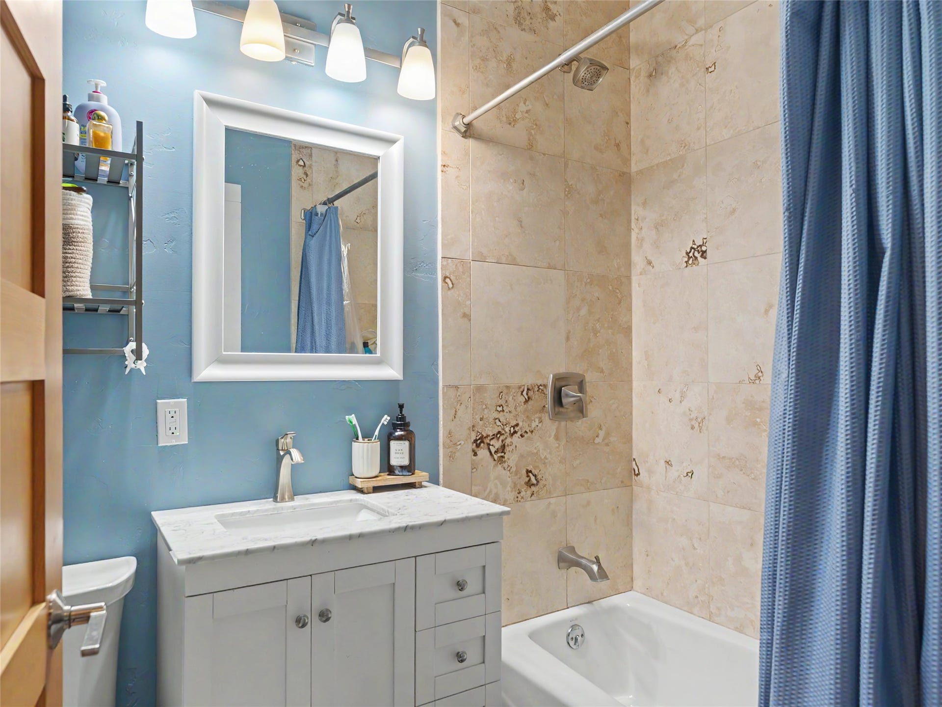 28012 Meadow Creek Road, Bigfork, MT 59911 2nd Bathroom featuring a white vanity with an integrated sink, polished chrome faucet, and coordinating light fixture