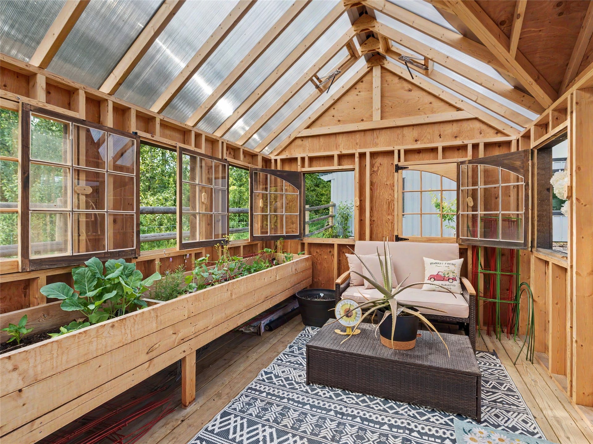 28012 Meadow Creek Road, Bigfork, MT 59911 Greenhouse structure featuring exposed wood framing and a translucent roof