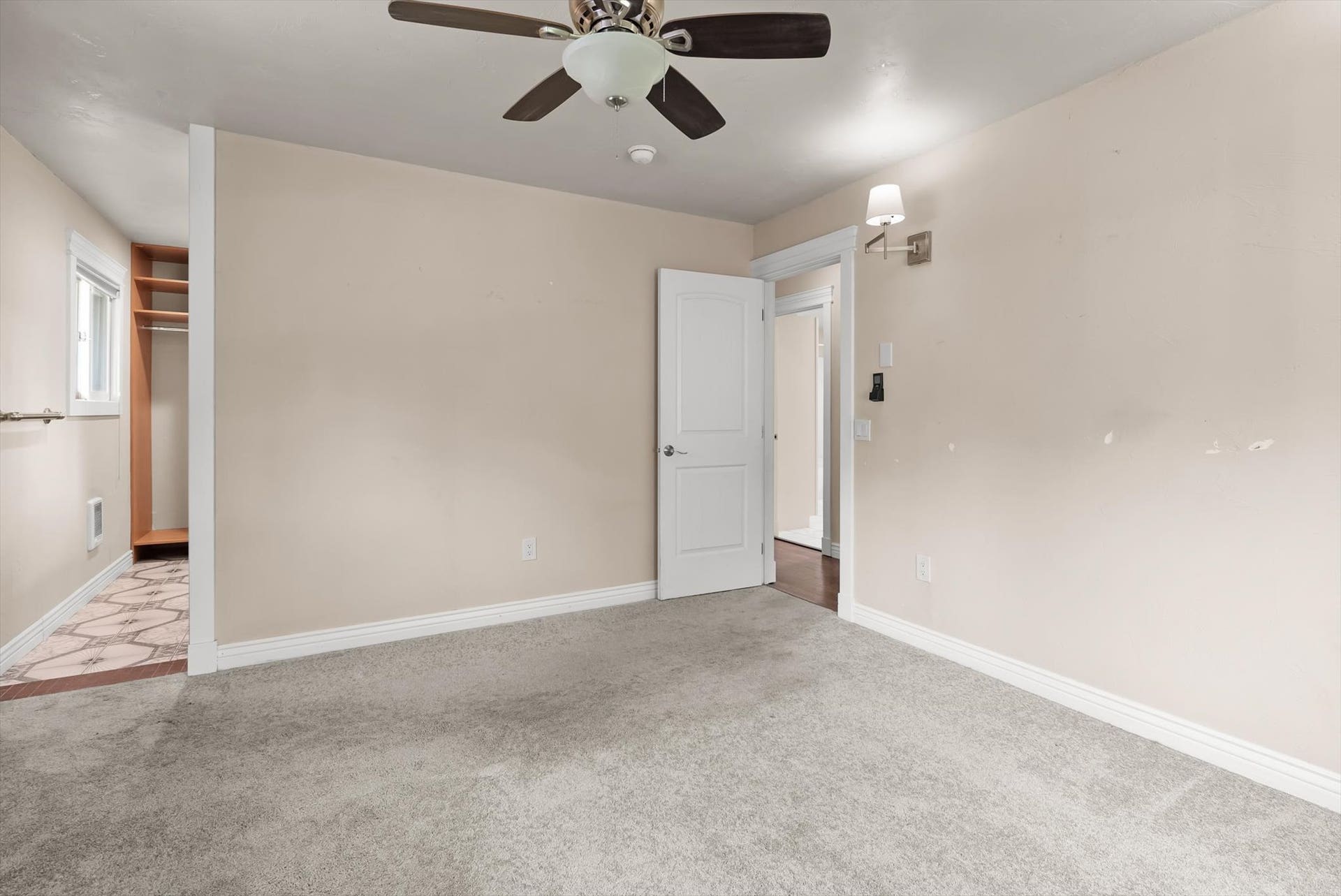 300 Peaceful Drive, Bigfork, MT 59911 Carpeted room with a ceiling fan and a built-in closet featuring wood shelving