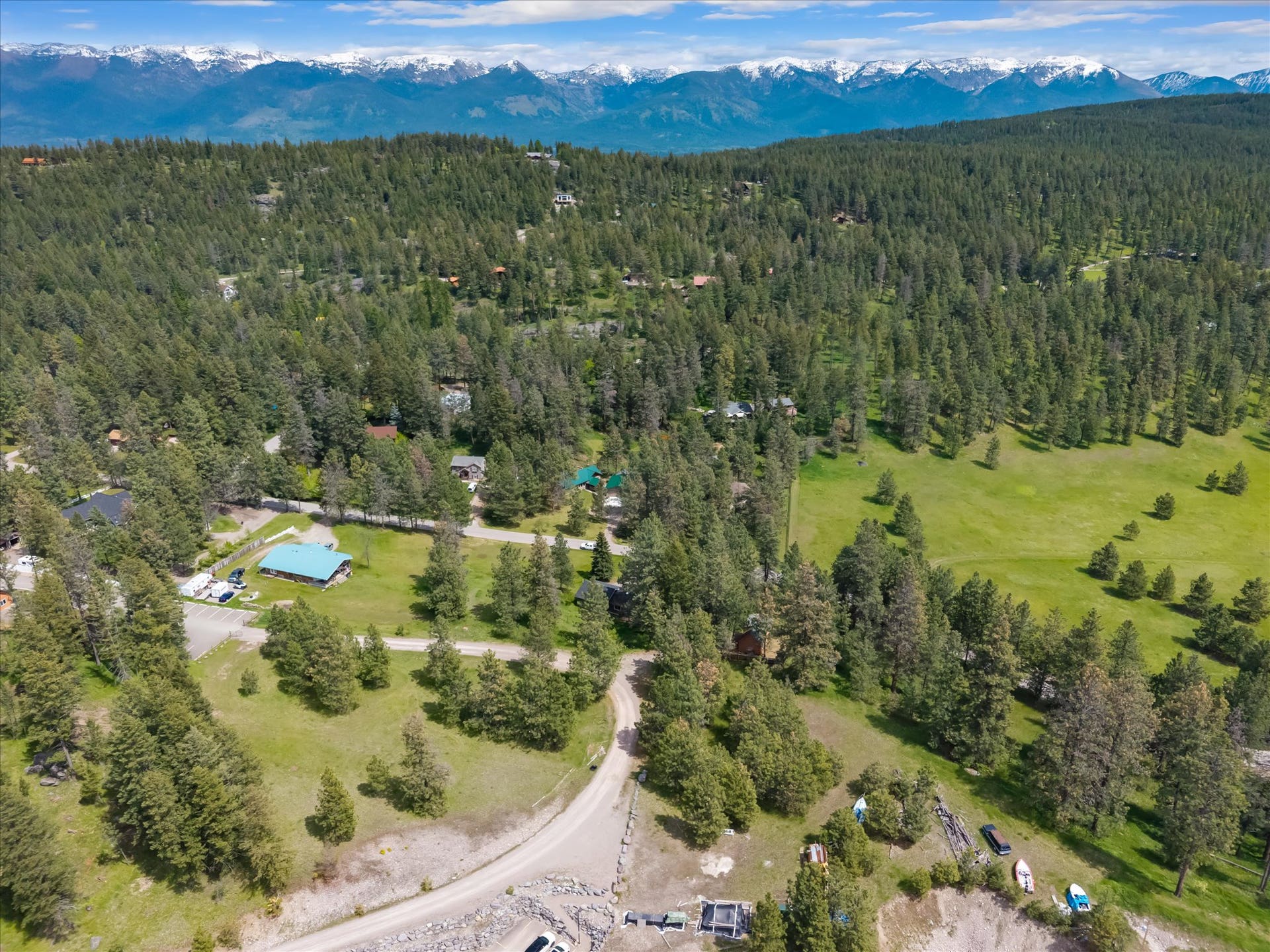 300 Peaceful Drive, Bigfork, MT 59911 Expansive wooded landscape with scattered clearings and distant snow-capped mountains