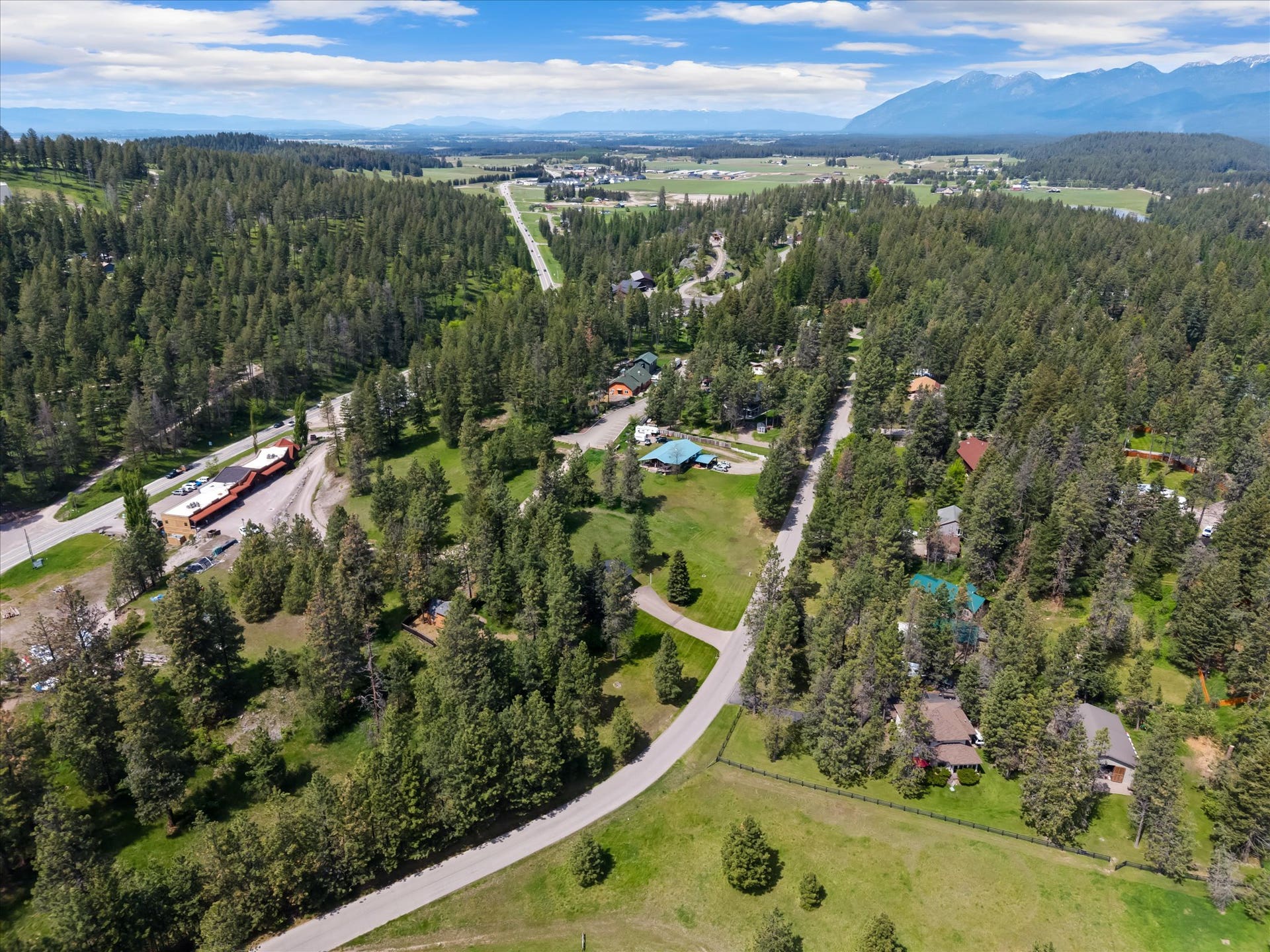 300 Peaceful Drive, Bigfork, MT 59911 Expansive wooded landscape with scattered properties and mountain backdrops