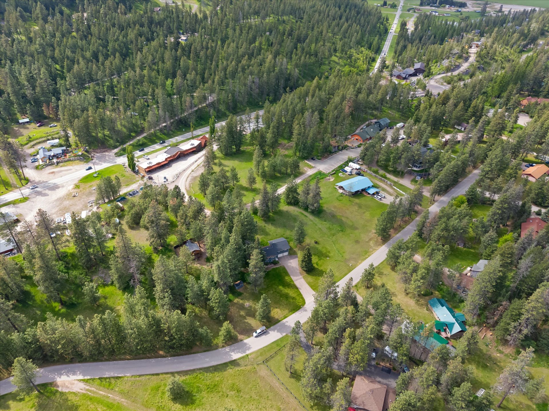 300 Peaceful Drive, Bigfork, MT 59911 Aerial perspective showcasing a verdant landscape with mature trees