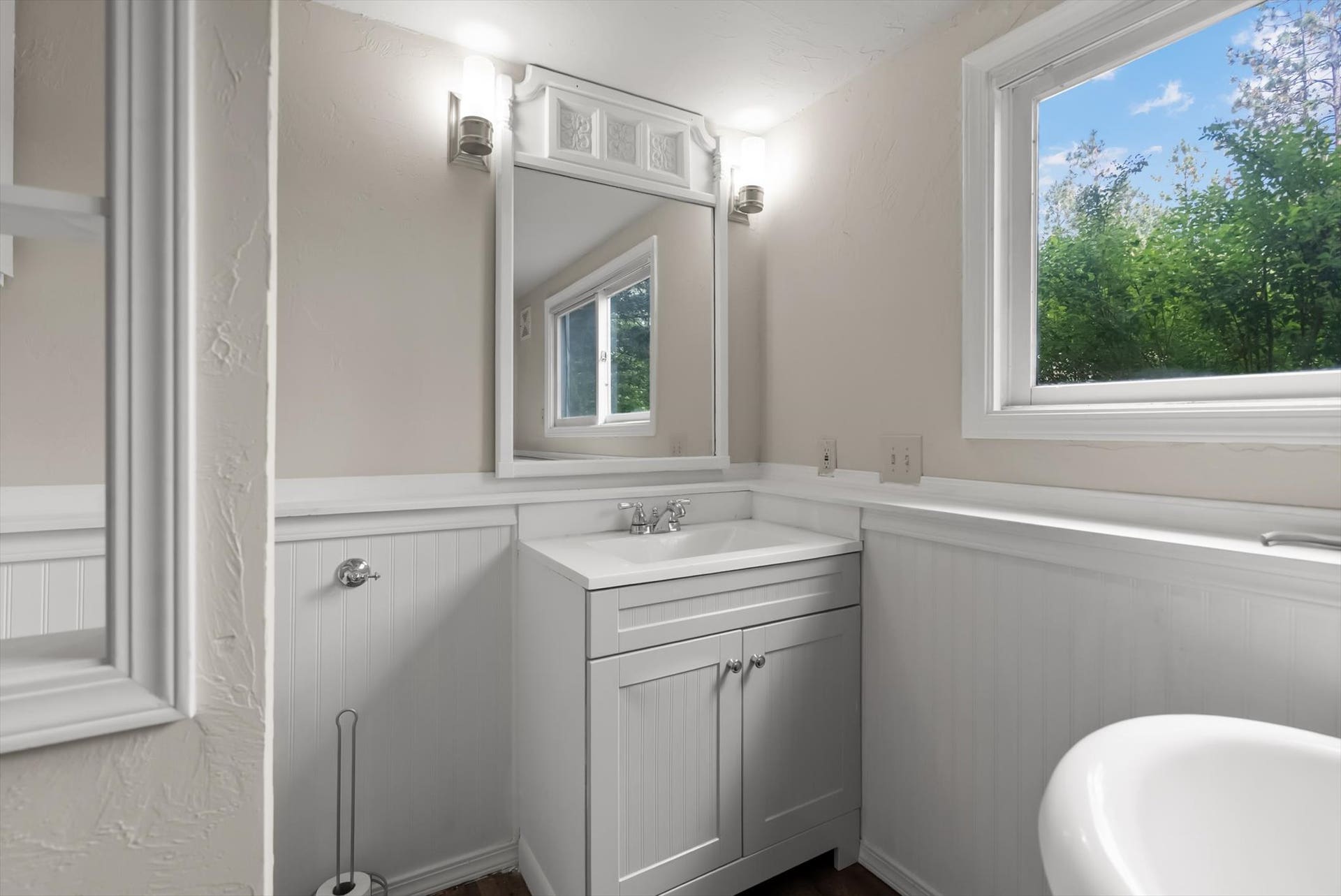 300 Peaceful Drive, Bigfork, MT 59911 White vanity with integrated sink, chrome faucet, and storage cabinetry