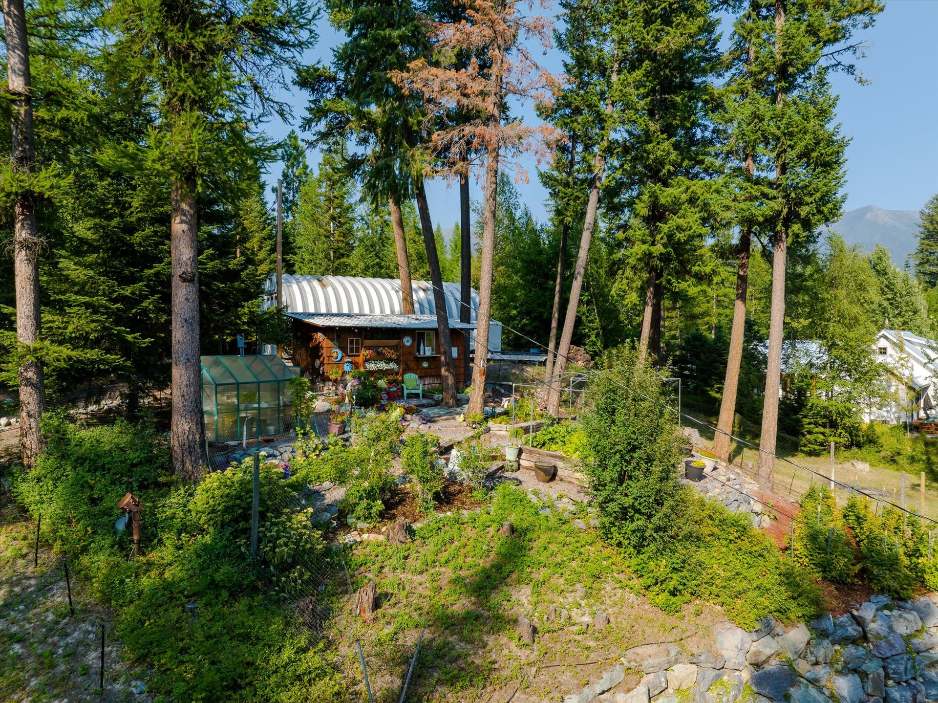 14259 Sunburst Drive, Bigfork, MT 59911 view of garden, shop, and Swan Mtns