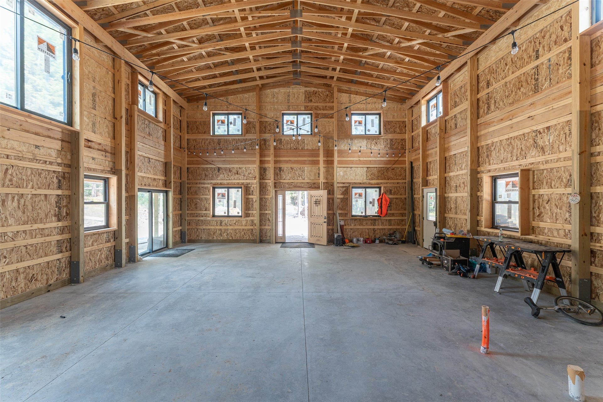 9653 Us Highway 2 W, Marion, MT 59925 Open-concept interior featuring exposed wood beams and a vaulted ceiling