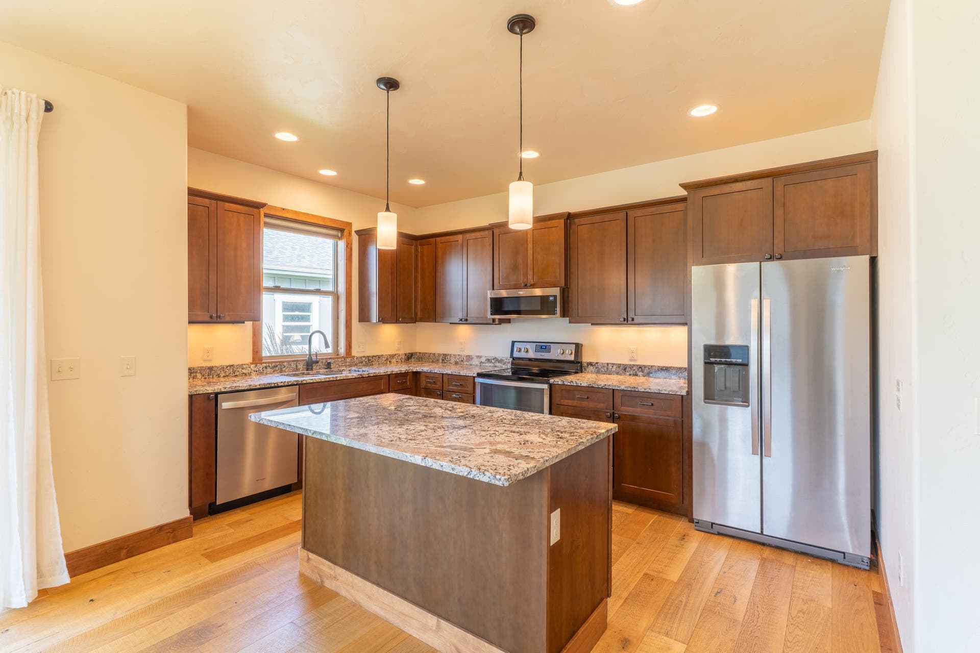 204 Bluebunch Court, Bigfork, MT 59911 Inviting kitchen with granite countertops & stainless steel appliances