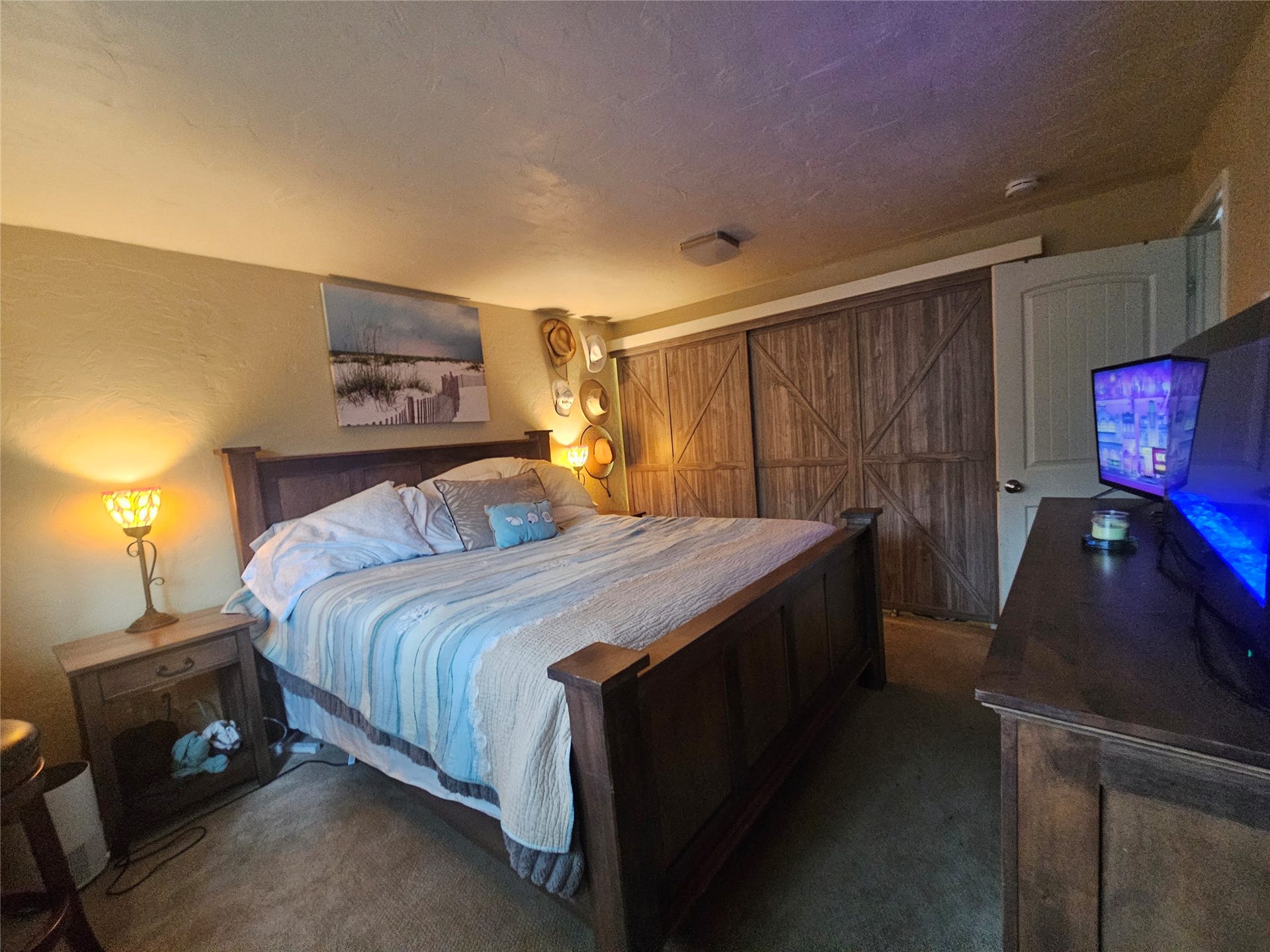 8575 Mt Hwy 35, #11, Bigfork, MT 59911 Bedroom 1 with closet system and barn door closet doors. Bed in photo is California King to show size of room.