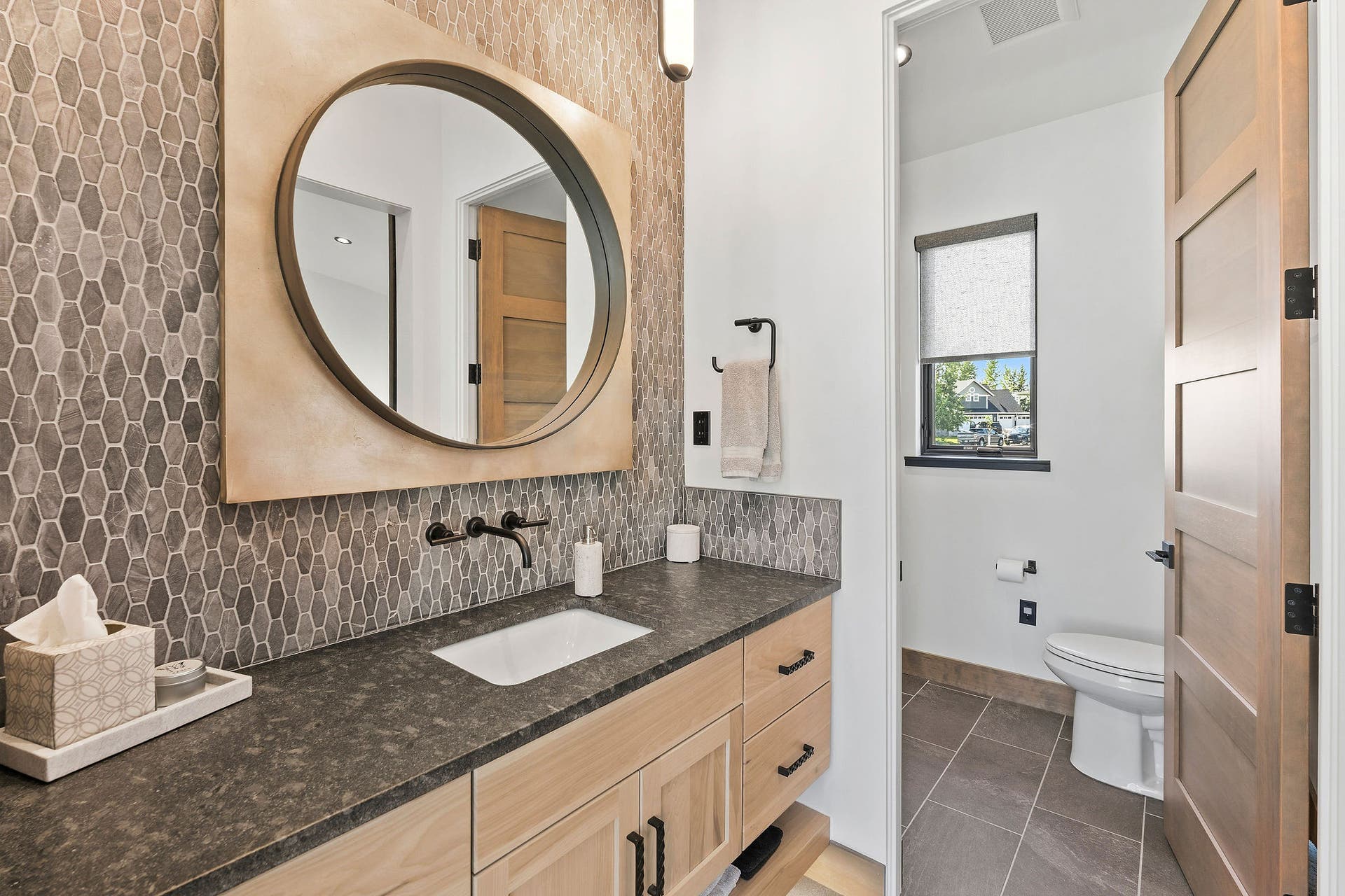1283 Lake Pointe Drive, Bigfork, MT 59911 Guest Bathroom #2 - black leathered granite countertop, dual entry access from hallway