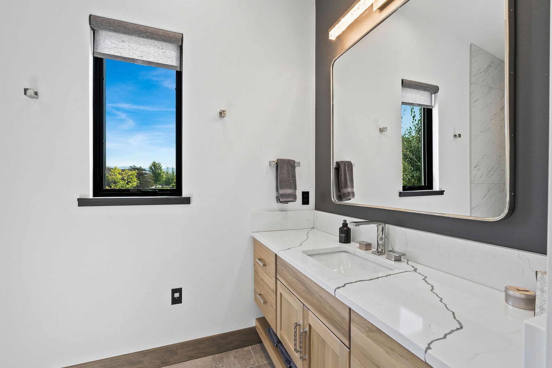 1283 Lake Pointe Drive, Bigfork, MT 59911 Guest Bathroom #1 - polished quartz countertop, large mirror