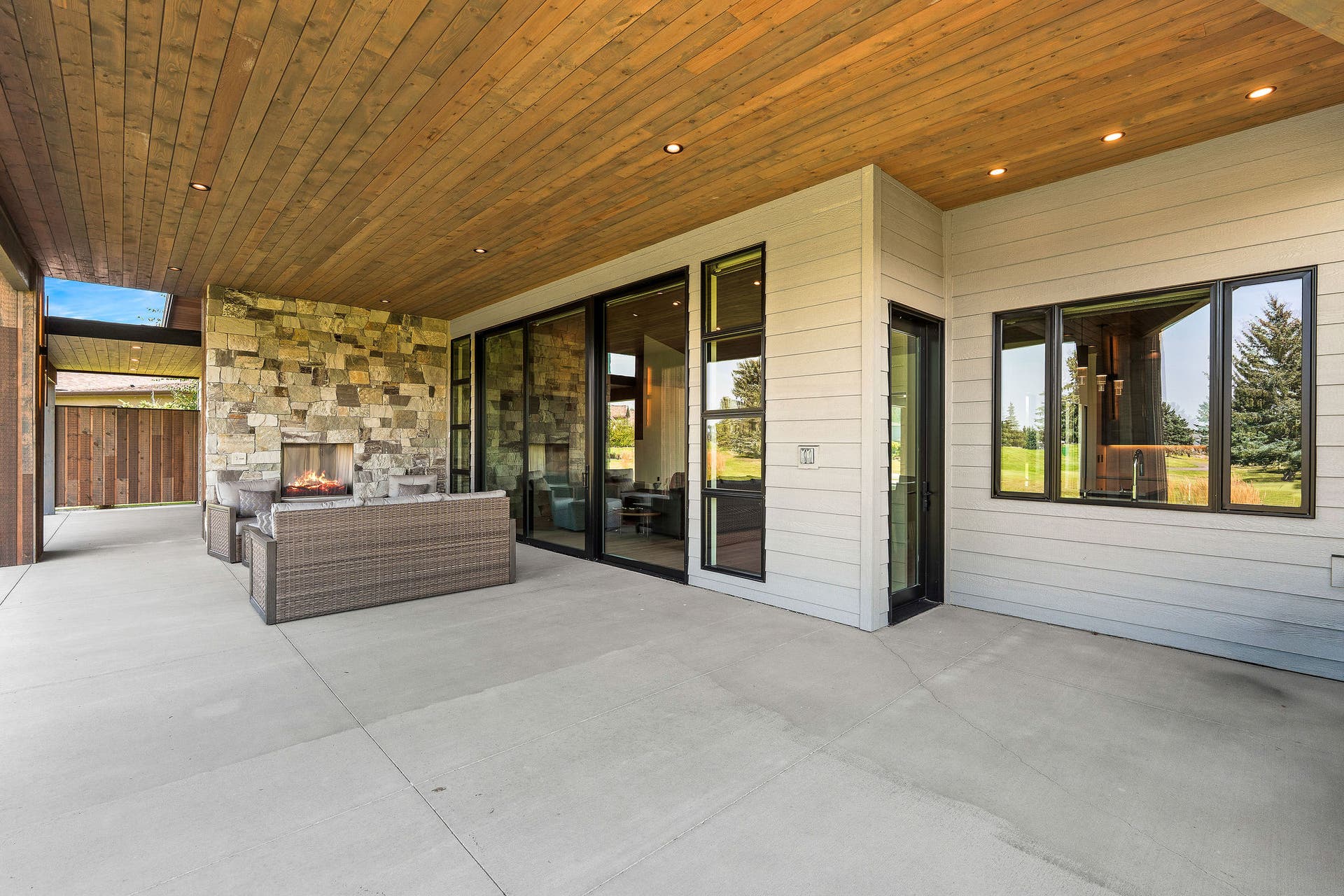 1283 Lake Pointe Drive, Bigfork, MT 59911 Covered patio with floor to ceiling rock wall