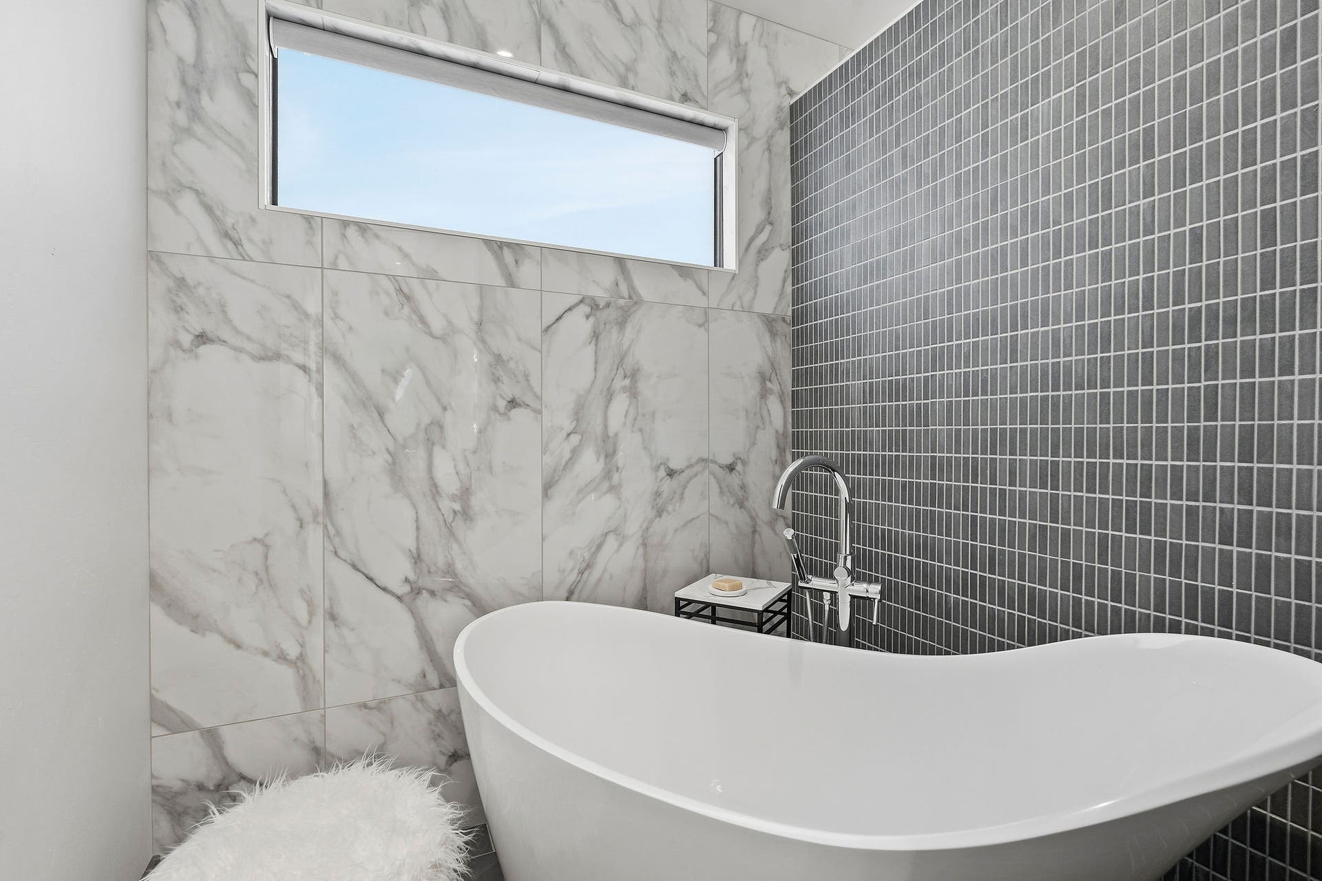 1283 Lake Pointe Drive, Bigfork, MT 59911 Private tub room with deep tub and tile and marble walls