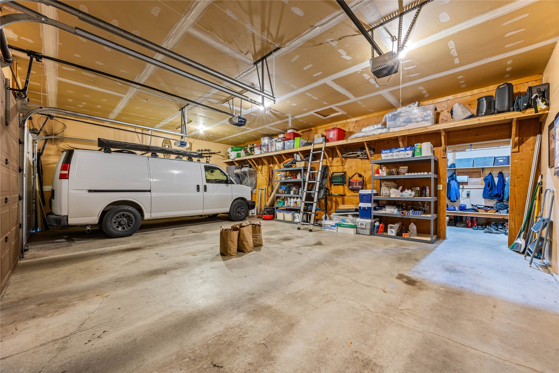 3 car garage.  
"Mudroom", workshop, and access to insulated cold storage.
