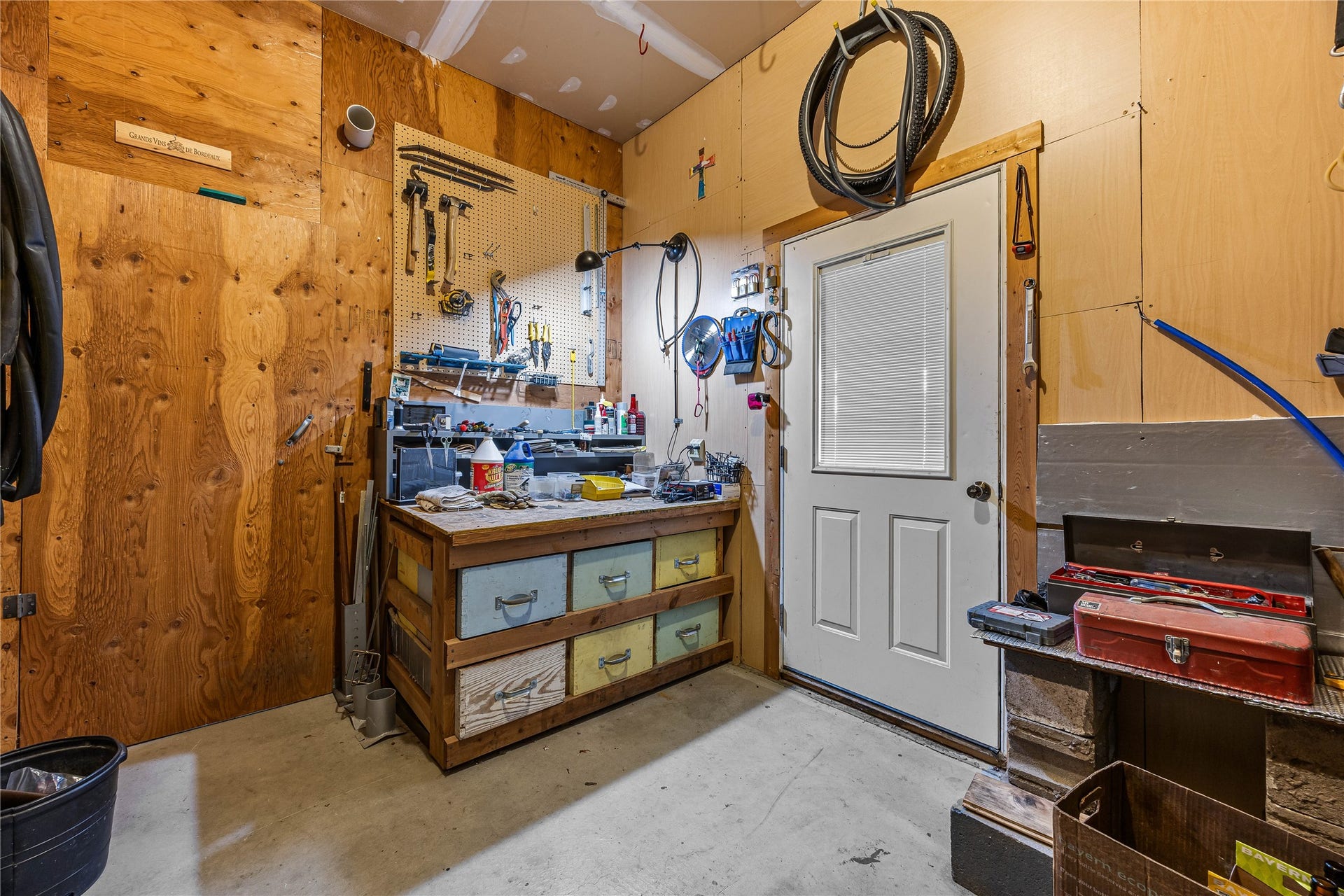Garage workshop area with insulated cold storage to the left.  Door to covered patio.