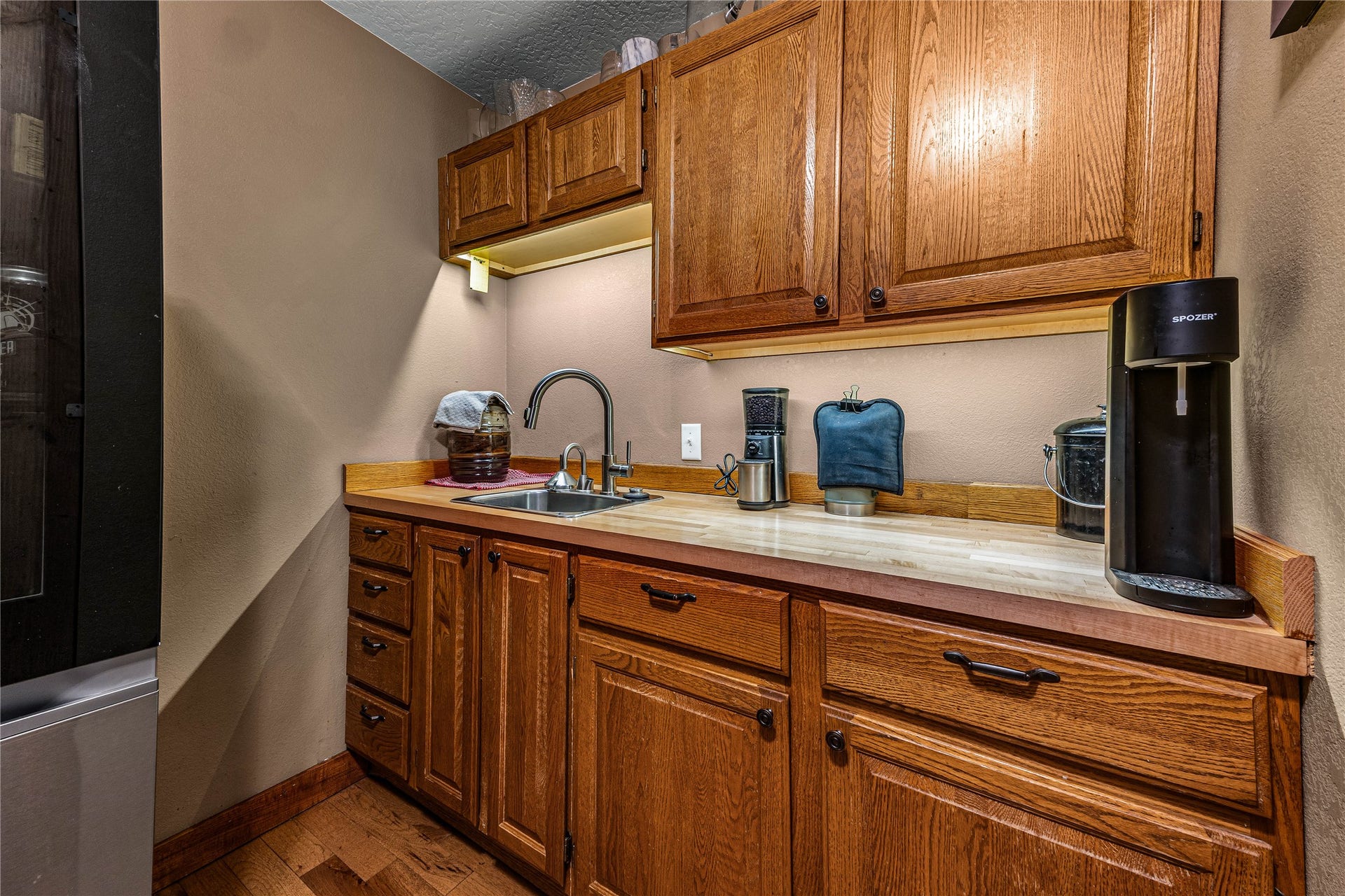 Butler's pantry with coffee station and sink.