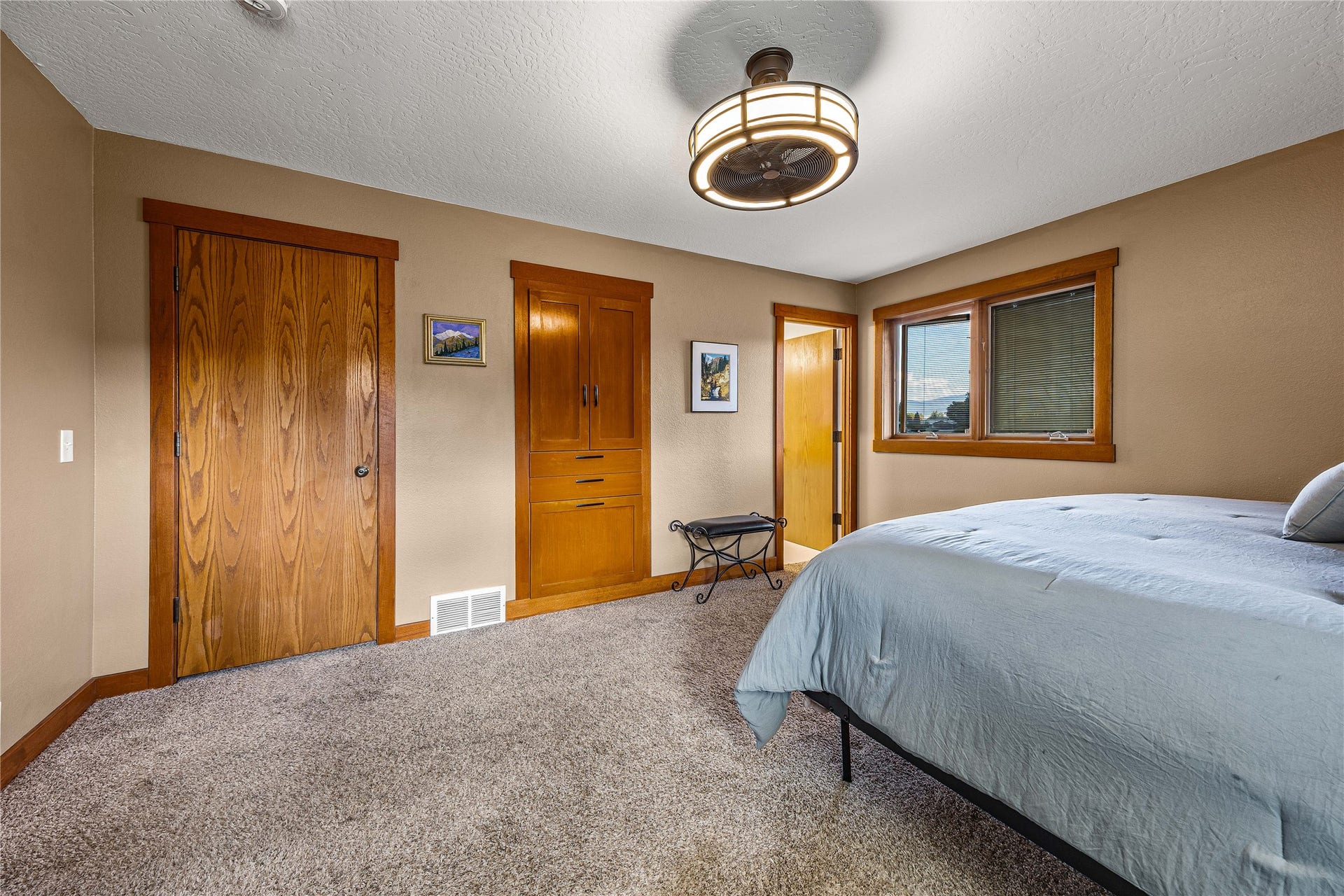 Primary bedroom with en suite bath and built in cabinetry.