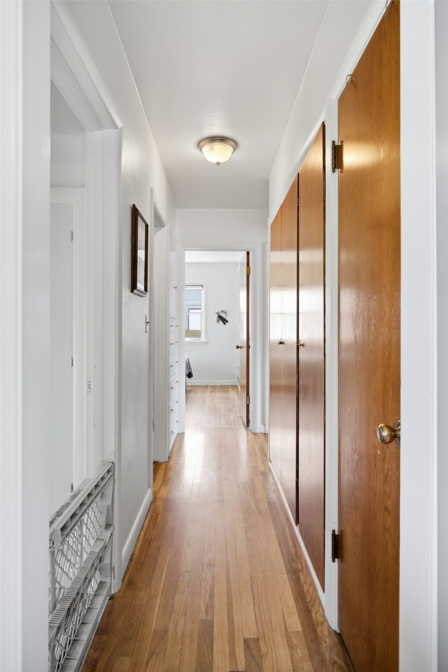 Hardwood flooring, recessed ceiling light, and panel doors