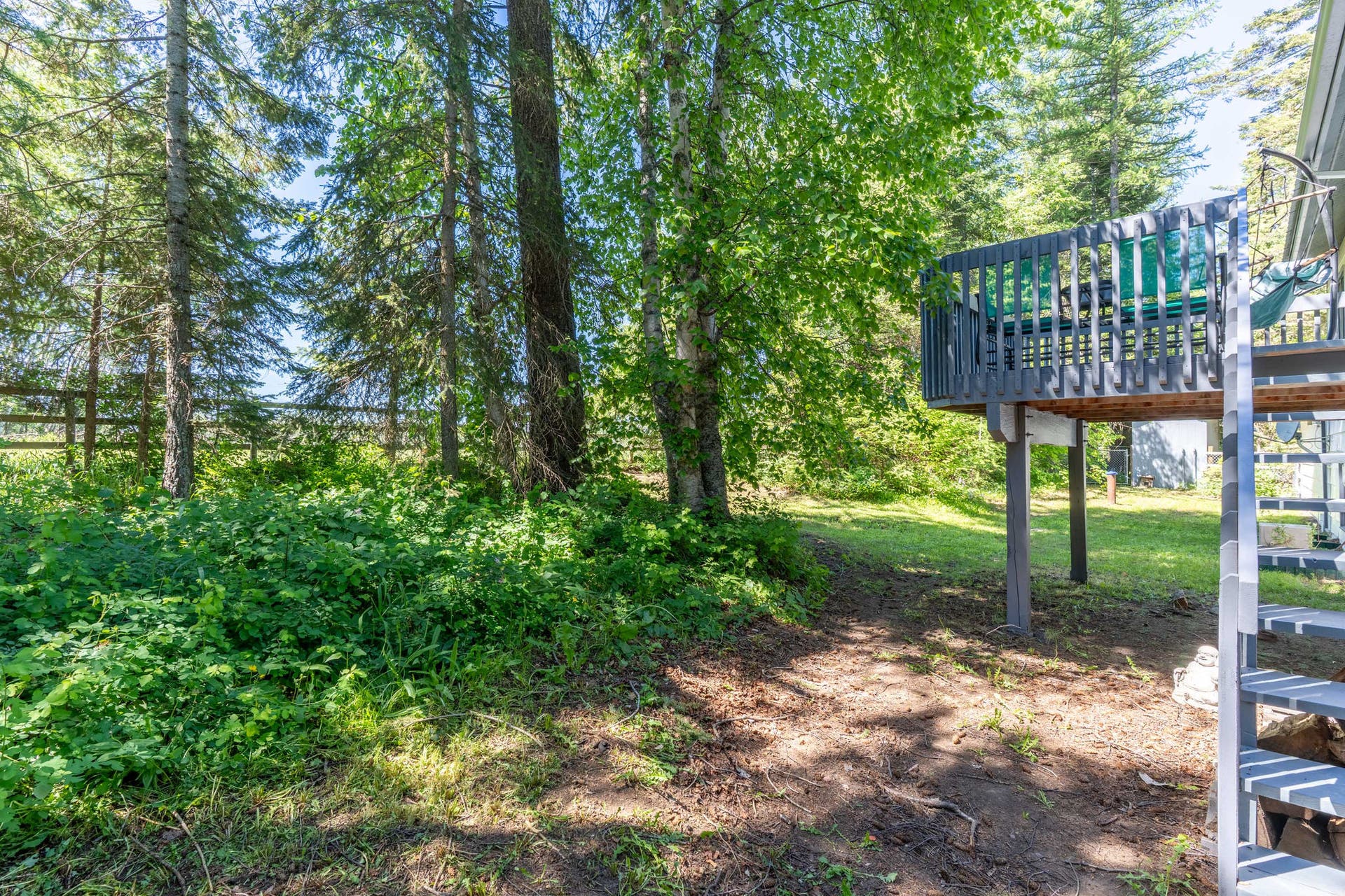 130 Alpine Drive, Bigfork, MT 59911 Wooded back deck and fenced back yard