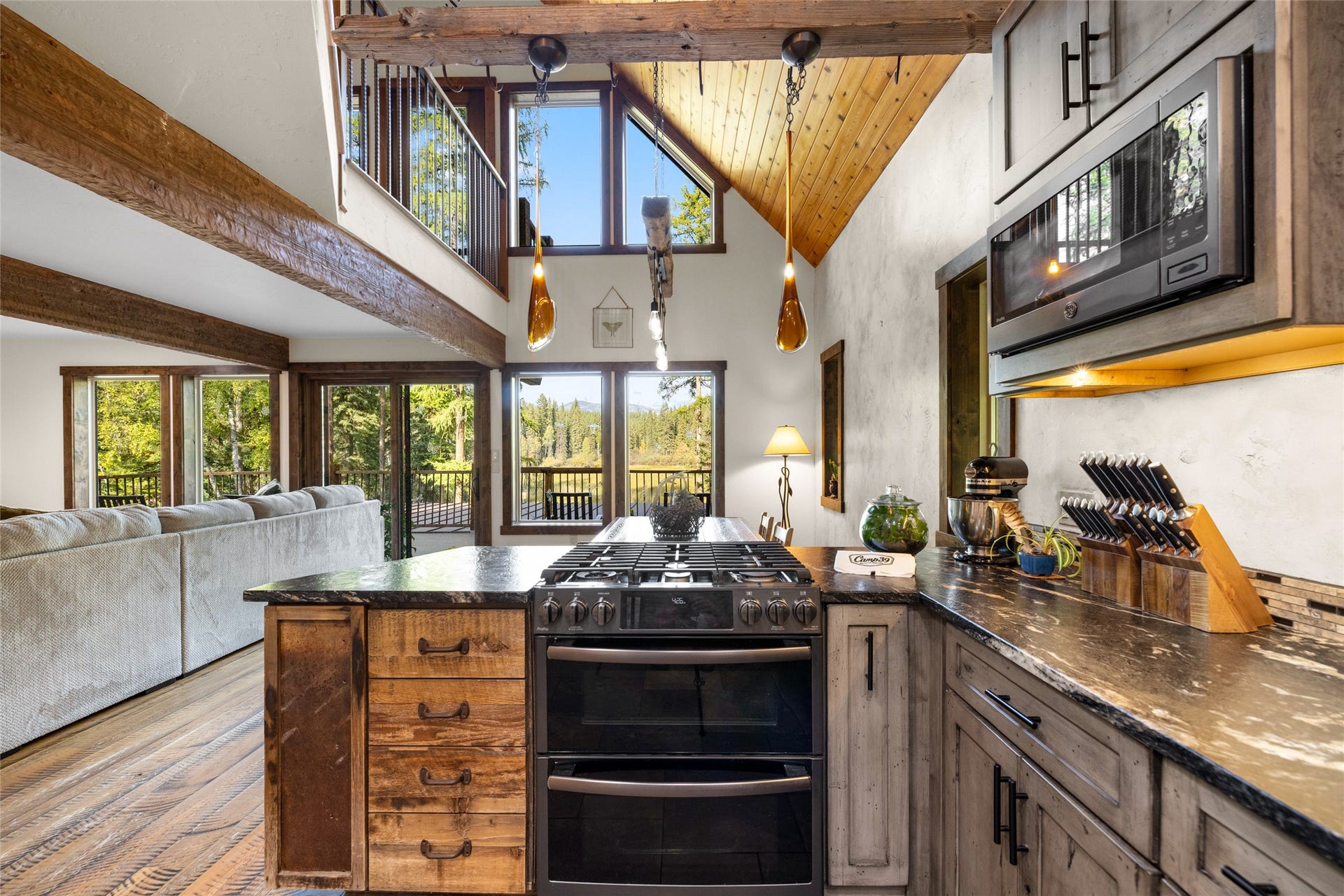 675 Beaver Lake Road, Whitefish, MT 59937 Warm Kitchen with Forest Views Beyond