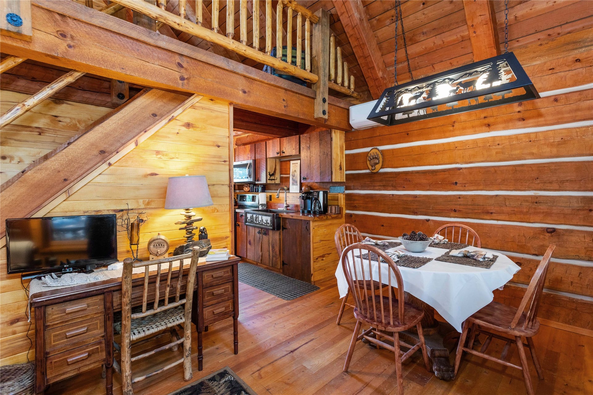 13518 Sylvan Drive, Bigfork, MT 59911 Bearly Asleep Cabin dining area with rustic metal chandelier