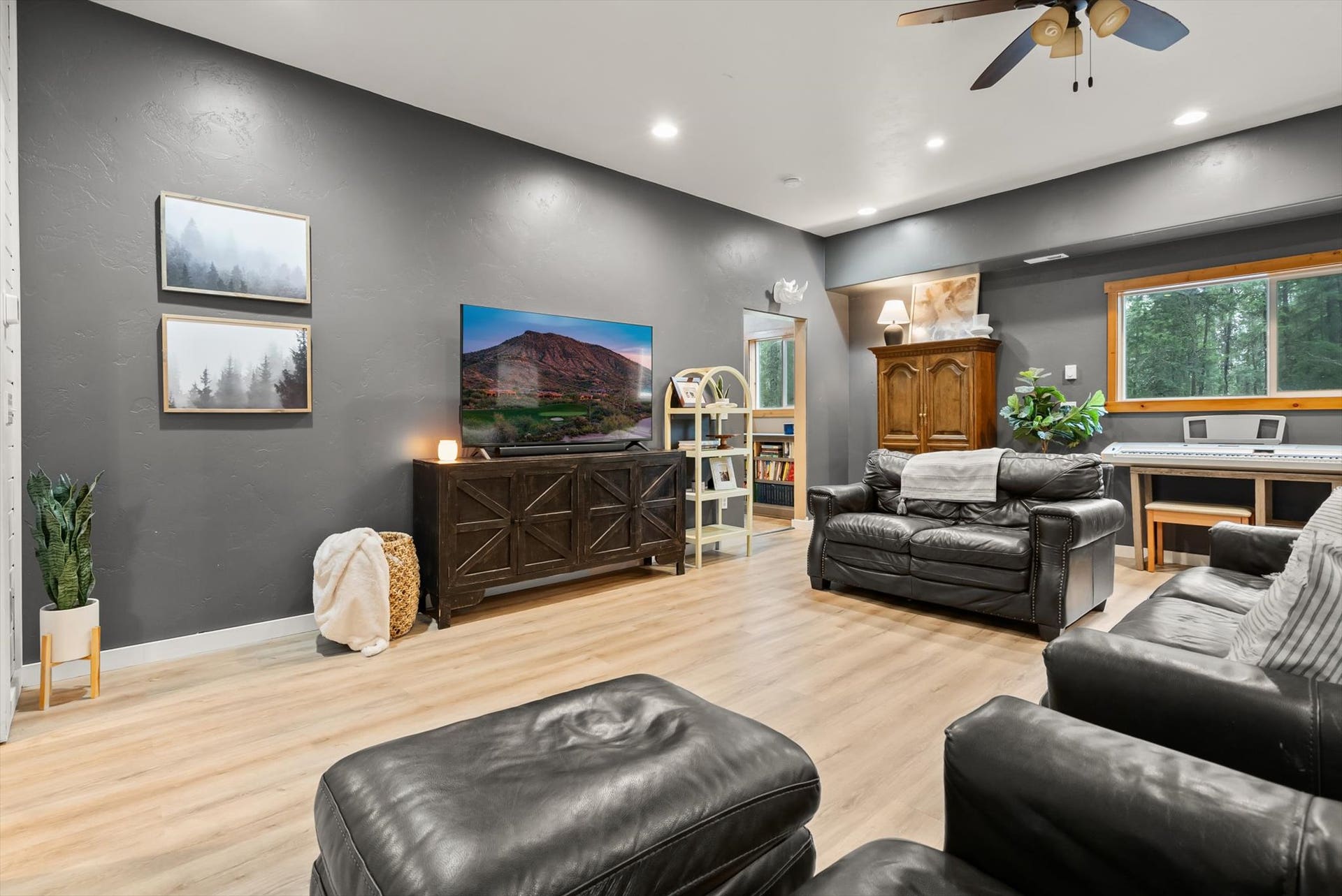 Designed for cozy Montana winters and casual entertaining, the spacious family rec room offers flexible living space with room for game tables, media setups, or a warm wood-stove gathering space.